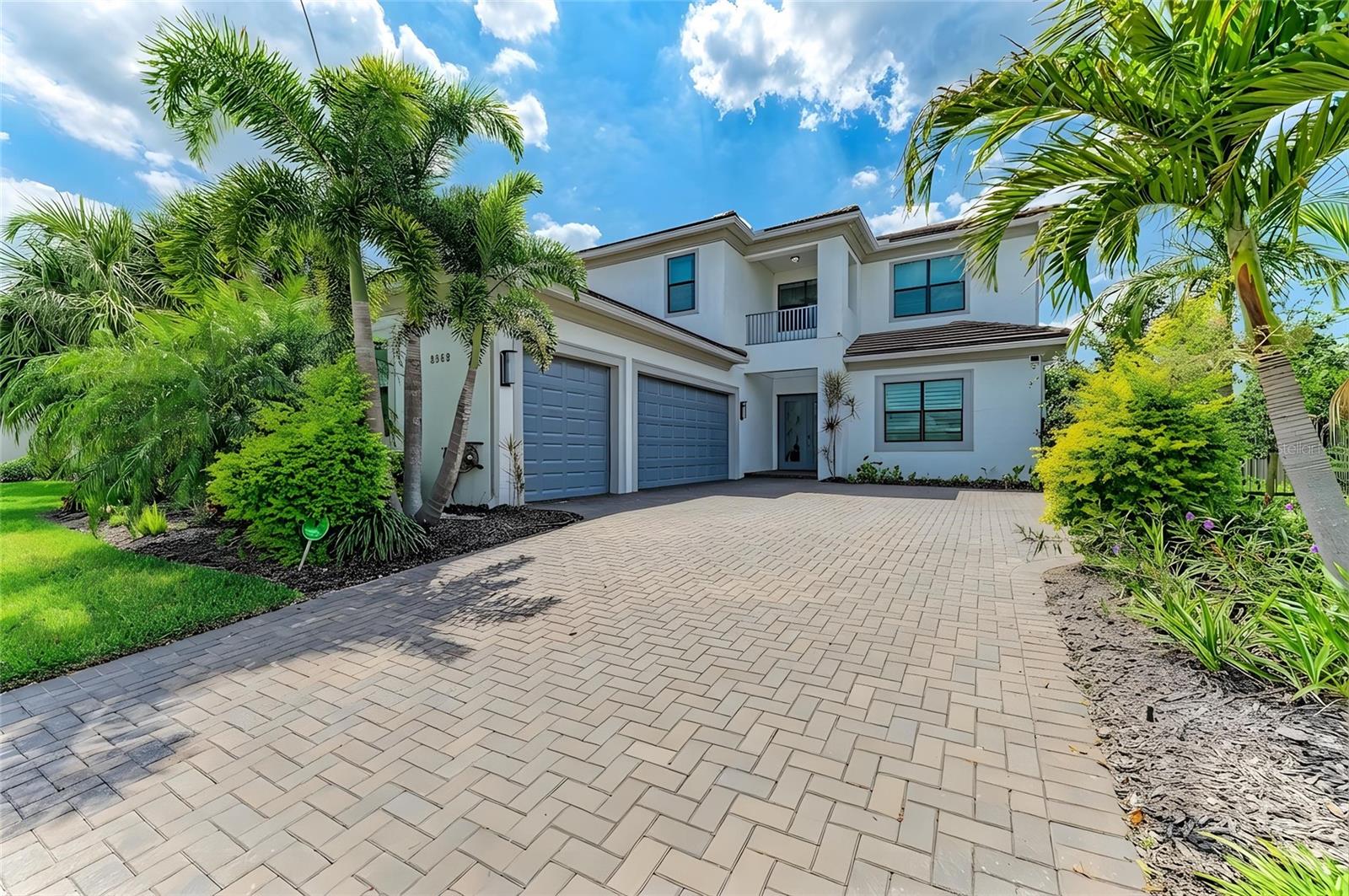One or more photo(s) has been virtually staged. Experience elevated living in this gorgeous newer Kolter Chagall home located in the highly desirable community of Artistry of Sarasota. Offering 4 bedrooms and 5 baths, along with a club room and loft area, this beautifully designed residence blends everyday comfort with upscale entertaining. With model like finishes throughout, the home showcases exceptional quality, style, and thoughtfully curated upgrades including coffered ceiling sets the tone upon entry, introducing the home’s refined architectural detail and airy elegance. At the heart of the home is a stunning open concept first floor, where the newly painted entry, living room, and kitchen create a fresh, bright, and welcoming atmosphere for both comfortable daily living and effortless entertaining. The chef’s kitchen features quartz countertops, a dramatic oversized center island with waterfall edge detail and generous seating, custom white shaker cabinetry, backlit upper display cabinets designed for decorative appeal, designer backsplash detail, GE Monogram wall ovens and gas cooktop, LG refrigerator and dishwasher, and abundant prep and storage space. The adjoining great room is enhanced by a coffered ceiling and custom accent wall, adding warmth, texture, and architectural interest. An abundance of natural light pours in through the sliders, creating a bright and airy atmosphere while drawing your eye out to the glorious spa like pool and zen inspired lanai. The first floor features a flex office/guest suite, full bath for guests, laundry room with built in shelving, and a beautifully appointed club room complete with a wet bar and wine fridge, offering the perfect setting for entertaining or unwinding. The first floor primary suite is a luxurious retreat with abundant natural light, custom built walk in closets, and a coffered ceiling that enhances the sense of elegance and scale. The spa like primary bath features dual vanities and a generous walk in shower. As you make your way upstairs, a staircase accented by a sleek horizontal metal railing adds a clean architectural element to the home’s modern design. Upstairs, there are three guest bedrooms and tow of them feature en suite baths and walk in closets, centered around a large loft area that offers the perfect setting for a media room, game room, or casual lounge for hosting family and friends. The outdoor living area is designed as a true private retreat, the screened lanai showcases a spectacular saltwater pool and spa with beautiful water features, a sun shelf with in pool seating, and a hot tub style spa area perfect for unwinding. Framed by travertine decking and lush green views, the outdoor space also features a striking pergola style architectural accent that enhances the resort like setting. The covered lanai includes an outdoor kitchen with bar seating and an additional generous seating area, creating the ultimate backdrop for entertaining, relaxing poolside, or enjoying peaceful Florida living. Upgrades include hurricane impact windows and doors, gas appliances, community irrigation, a mini split in the garage, and a Briggs & Stratton whole house generator. Located in the gated, amenity rich community of Artistry, residents enjoy maintenance free living with access to a resort style pool, clubhouse, pickleball courts, basketball court, playground, and scenic walking trails. Ideally located near world class shopping, dining, and Sarasota’s renowned beaches, this home is high and dry located in zone X.