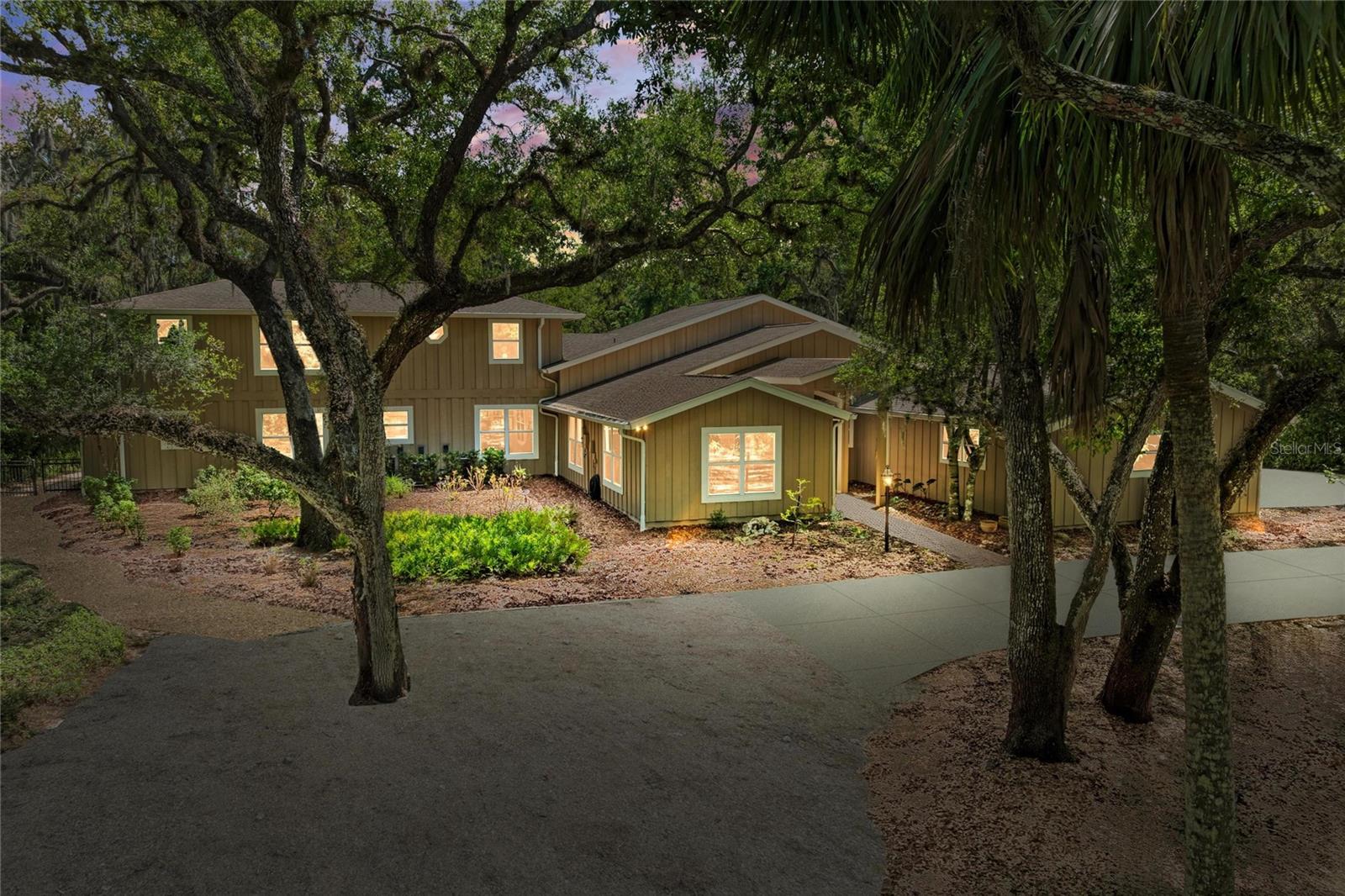 Centrally located yet secluded under a canopy of one-hundred-year-old oak trees, this exceptional Bradenton estate offers a rare nature lover’s sanctuary where serenity and convenience exist in perfect harmony. Set on 2.4 lush acres with native Florida landscaping, the property creates a peaceful, park-like setting and a thriving habitat for birds and butterflies, rich in privacy and timeless Old Florida charm. Spanning more than 3,800 square feet, the residence blends generous living spaces with warm architectural character, offering four bedrooms and four bathrooms, including three private en-suite retreats ideal for family living or hosting guests in comfort and style. At the heart of the home, a dramatic family room features soaring 12-foot ceilings and two walls of windows that flood the space with natural light while framing picturesque views of the surrounding landscape. French doors open seamlessly to the screened lanai, where indoor and outdoor living unite around a newly resurfaced swimming pool, perfect for relaxed afternoons or effortless entertaining. The thoughtfully designed chef’s kitchen showcases abundant maple cabinetry, granite countertops, a prep island with sink, and premium appliances. A bright breakfast nook overlooks the pool and lush grounds, creating a tranquil space to begin each day surrounded by nature. The upstairs primary suite serves as a peaceful private retreat, complete with two walk-in closets, a comfortable sitting area, and a beautifully updated spa-inspired bath featuring dual vanities, custom cabinetry, granite countertops, a soaking tub, and an expansive walk-in shower. Meticulously maintained, the home features new interior lighting, renovated bathrooms, and a roof installed in 2017 with a transferable warranty. Seller is offering a One-Year Home Warranty for added peace of mind. From the moment you arrive, it’s clear this property is truly special. The expansive acreage offers endless possibilities for outdoor living, recreation, gardening, or simply enjoying the quiet beauty of nature. Located within the NO deed-restricted Braden Oaks community, residents enjoy both freedom and convenience. Shopping, dining, schools, and medical facilities are just minutes away, while major highways lie less than four miles from the home, placing Sarasota, Bradenton, St. Petersburg, and Tampa within easy reach. Pristine Gulf beaches, world-class golf courses, and Sarasota-Bradenton International Airport are all under 30 minutes away. Be sure to watch the drone video to fully appreciate the size, privacy, and beauty of this exceptional property and its stunning surroundings. Schedule your private showing today. Be sure to check out inside drone video tour!