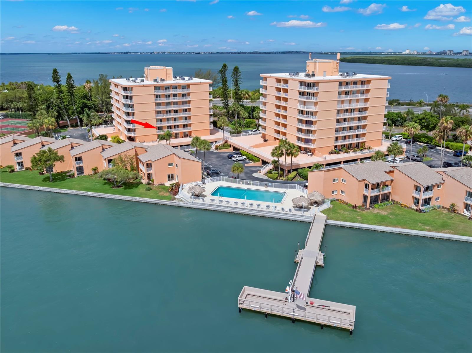 Virtually Staged. WELCOME HOME to your Spacious 2 Bedroom, 2 Bath waterfront condo in South Bay! Enjoy the open floor plan with split bedroom suites with walk out sliding glass doors from every room to the expansive balcony with amazing views of Tampa Bay.  The kitchen offers wood cabinetry with contemporary hardware, granite countertops, stainless appliances including a glass-top range with double ovens. The private laundry closet is located in the kitchen for ease of access.  This home is perfect for entertaining with its bright natural light, a flawless flow from kitchen to dining and living areas. Enjoy your morning with the most incredible sunrises and quiet evenings overlooking the Bay with views of dolphins, birds and seacoast breezes.  Your Primary suite features a walk-in closet, ensuite bath, vanity area plus balcony access through a private sliding glass door set. The Guest Suite also offers a Private ensuite bath for guests along with their very own private sliding glass door for balcony access. All of the sliding glass doors have roll down storm shutters for peace of mind and safety. Another fantastic feature is your assigned under-building parking near the entry door plus a generous number of guest parking. South Bay residents have access to resort-style amenities including a Heated & Cooled Pool with Tiki cabanas, clubhouse, and new private fishing dock. The community welcomes all-ages, is pet-friendly (up to 25lbs), and is ideally located near the on and off ramps from Interstate 275. The entry to the Skyway Trail right out the front door of the building with many parks, golf courses, tennis and pickleball, within reach. Less than 10 minutes to walk or bike to Maximo Park or take a short drive to Shopping, Restaurants, Art Galleries, Downtown St Pete, our award winning Gulf Beaches, Ft. DeSoto, Skyway Fishing Pier State Park or multiple Marinas and boat launches. On-site Property Management and Maintenance are mere steps away.
Don’t miss out on this amazing opportunity to experience maintenance-free living in a waterfront community. The unit is vacant and waiting for YOU! Call today to schedule your private tour.