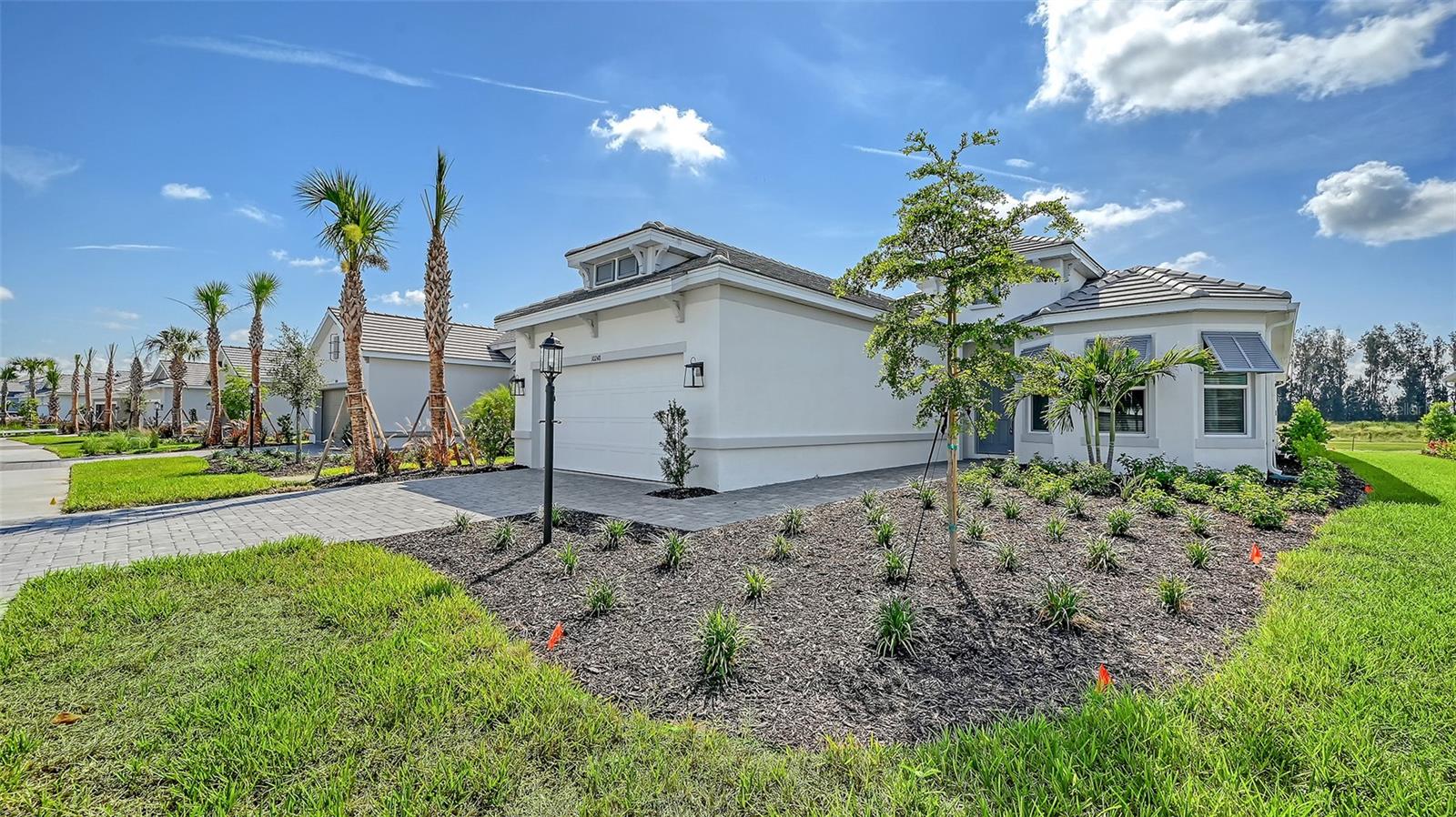 Experience refined Florida living in this newly built elegant 3-bedroom, 3,5-bath residence with a private den and attached 3-car garage. Thoughtfully designed and beautifully appointed, this home offers an effortless blend of sophistication, comfort, and functionality. Every detail reflects quality craftsmanship—from the gourmet kitchen featuring quartz countertops, oven, and premium cabinetry to the tray ceilings accented with crown molding. The open-concept layout flows seamlessly from the main living spaces onto a spacious lanai (screening to be done) The lanai’s tranquil water views create a serene and secure outdoor retreat, ideal for entertaining or unwinding in peace. Elegant luxury vinyl flooring adds warmth to the areas. The home’s soft, neutral color palette and tasteful finishes provide a timeless backdrop suited to a variety of décor styles. A second bedroom with an ensuite bath enhances privacy and versatility for guests or family. With its luxurious upgrades, thoughtful layout, and captivating water vistas, this home offers the perfect balance of style and relaxation—crafted for those who appreciate quality and understated elegance. Zoned for Skye Ranch Schools and Riverview High School.