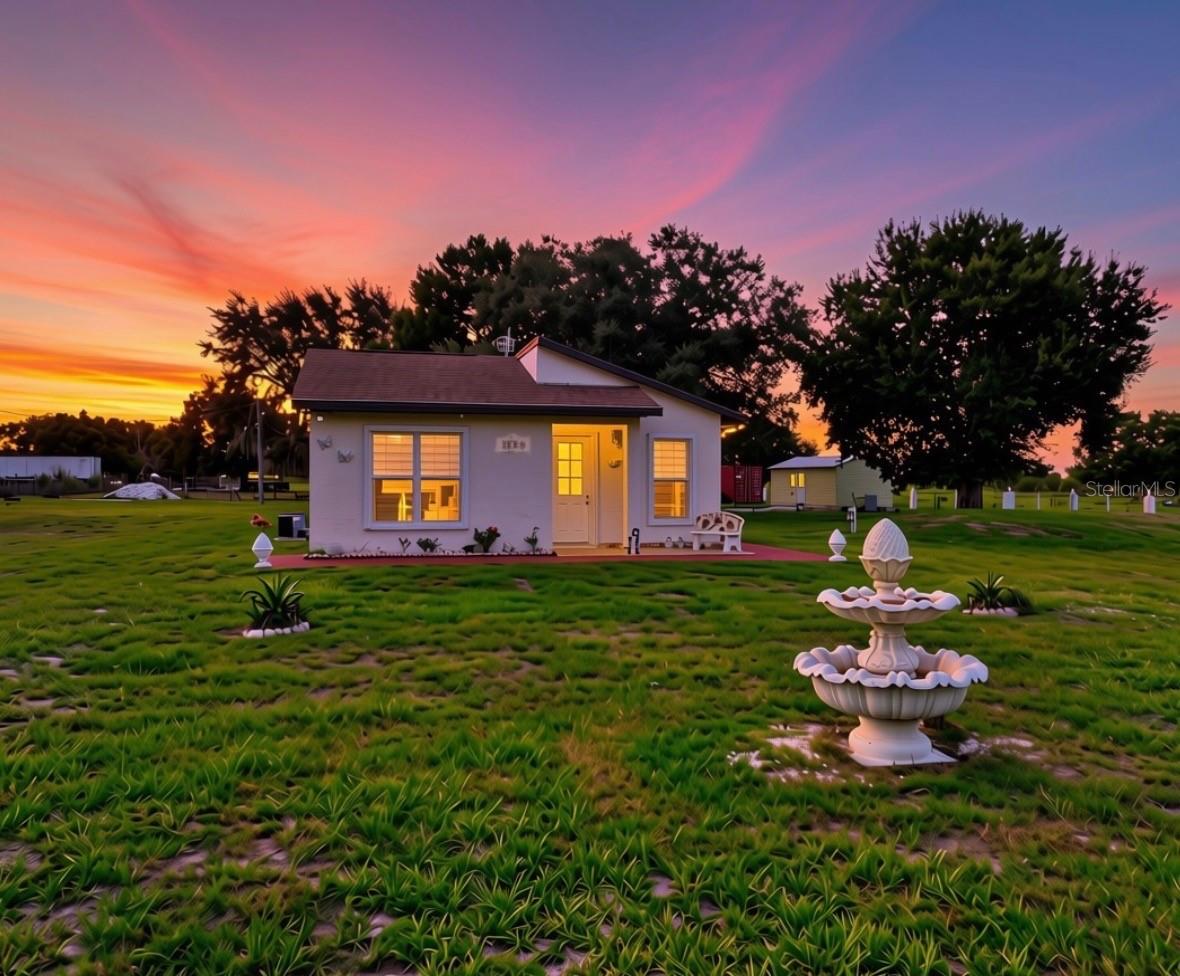 Discover the perfect balance of comfort, privacy, and functionality with this immaculate 2021 concrete block home situated on 5.01 fully fenced acres at the end of a quiet dead-end road in Zolfo Springs. Zoned A-1, this property is ideal for horses, livestock, chickens, or anyone seeking the freedom and versatility of country living. Inside, the 2-bedroom, 1-bath home features vaulted ceilings, abundant natural light, granite countertops, custom cabinetry, stainless steel appliances, and tile flooring throughout. The kitchen flows effortlessly into the main living area, creating a welcoming space for everyday living and entertaining. Hurricane shutters on every window provide added peace of mind. Step outside to enjoy two outdoor kitchens, a spacious covered patio, fenced pastures, and animal pens already in place. Two wells support both residential and agricultural use, while a storage building and shipping container providing ample room for equipment, tools, and supplies. Whether you’re looking to establish a hobby farm, bring your animals home, or simply enjoy the peace and privacy of country living, this exceptional property offers the space and flexibility to make it your own.