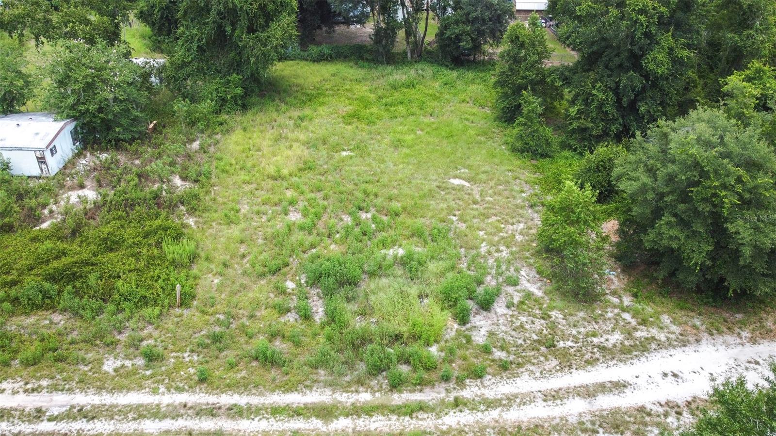 Discover the perfect backdrop for your custom home with this serene quarter-acre homesite (Parcel S15A218) in peaceful Sumter County. Skip the compromises of buying an established house and design a space that truly fits your lifestyle. This lot delivers the ideal blend of a quiet, off-the-beaten-path feel while keeping everyday conveniences within easy reach.
Developing the property is highly practical, as recently improved roads lead the way to electricity utilities and engineering already completed right on the street. Infrastructure planning is also streamlined by a strong local track record, with nearby lots seeing consistent, straightforward success for standard septic installations and well drilling.
The location comes with excellent lifestyle bonuses as well. As the owner of this property, you will enjoy private, deeded access to the neighborhood lake. Additionally, the nearby County Park offers a great setup for weekend recreation, featuring a boat ramp, barbecue areas, and plenty of open space. Turn your real estate goals into reality right here.