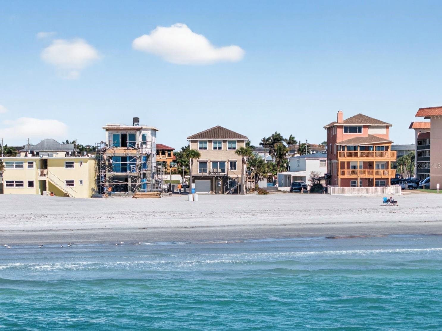 Welcome to a truly rare Gulf-front opportunity in the heart of Redington Shores—where panoramic water views, breathtaking sunsets, and the beauty of Florida’s coastline come together in perfect harmony. Built in 2015 with solid concrete block construction on the base level and designed to FEMA standards, this home offers both peace of mind and lasting quality. From the moment you arrive, you are welcomed by unobstructed, panoramic views of the Gulf from every level of the home. With approximately 40 yards of pristine sugar sand beach directly in front of you, the setting feels both expansive and private—your own stretch of paradise along the shoreline. What truly sets this home apart is the experience it offers each evening. The sunsets here are nothing short of extraordinary—endless skies painted in vibrant hues of gold, pink, and orange, reflecting across the water as the day gently fades into night. Whether you are relaxing on your balcony or entertaining guests, these nightly sunsets become a breathtaking backdrop to everyday living. The home is thoughtfully maintained and move-in ready, featuring numerous updates including two new air conditioning systems, a new electrical service installed by Duke Energy, a new water softener system, and a brand-new washer and dryer. Hurricane roll-down shutters on the Gulf-facing sides provide additional protection, while LED lighting and blackout blinds add efficiency and comfort for laid-back beach living. The structure itself remains strong and sound, offering confidence in its construction and longevity. The roof and overall structure remain in excellent condition, further reinforcing the quality of the home. Situated on a quiet cul-de-sac just off Gulf Boulevard, the location offers a rare blend of privacy and convenience. There is also the opportunity to add a pool, further enhancing your outdoor living space and creating a true coastal retreat. Redington Shores is known for its relaxed coastal charm and its beautiful, uncrowded sugar sand beaches. Unlike more heavily traveled areas, this community offers a peaceful and serene lifestyle while still being close to local dining, shopping, and entertainment. Here, life slows down: you can take long walks along the shoreline, enjoy the sound of the waves, and fully embrace the natural beauty that surrounds you. This is more than just a home—it is a lifestyle centered around waterfront living, unforgettable sunsets, and the simple luxury of waking up and ending each day by the water.