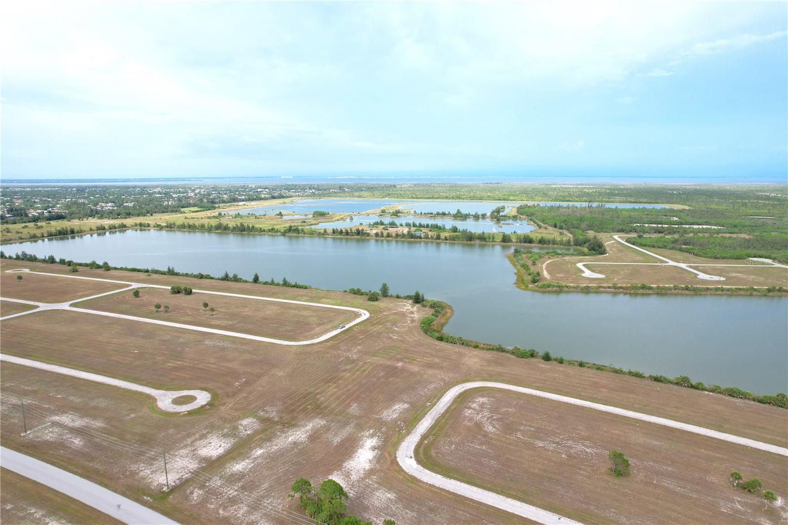 Best LakeFront lot in Rotonda Meadows. 1 Oversized lot overlooking the largest lake and the lot next door which has the lake view. Added 40 ft of Buffer in between the two lots.  Lots 23 & 25 (25 Lake front).
Best Lake front lot in Rotonda Meadows.  Buy and build or invest and wait. Over sized Lot. Lot size: 0.377 of acre = 16.167 sq ft. 140x100x180x113. Great location to invest or build your new home. Pick your own builder or ask for help. Conveniently located close to I-75 and local amenities, beaches, and Tiki Bars and Live entertainment daily. The best Tarpon and red game fishing in the world with off speed boat racing to spring training baseball teams as The Atlanta Braves and Tampa Rays baseball teams. Just want to go to the local beaches (Port Charlotte, Boca Grande, Englewood and Sarasota beaches) or go fishing for the day. Great to do it all with whatever you can dream or do as a hobby. Local International Airports: Fort Myers, Sarasota and local Punta Gorda with Allegiant airlines direct. Many outdoor concert venues weekly. Many local Tiki Clubs watch live entertainment to have a Sunset view. Local parks, state parks, tennis or pickle ball, to amazing golf courses. You deserve to view this property and make it your home or investment.