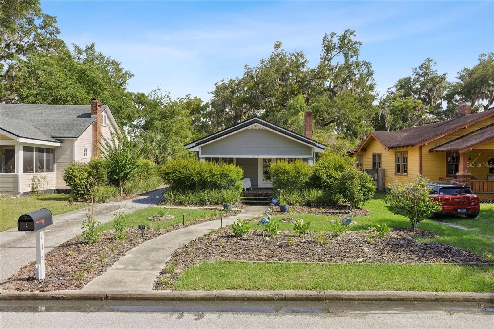Welcome to 117 W 19th! This completely remodeled 1930s Sanford home is ready for you! FULLY renovated in 2019, everything in this home is 7 years old or newer! With beautiful curb appeal adding tons of natural shade, you enter through your COVERED front porch to your open living room! Overlooked by your beautiful kitchen, with LEATHER GRANITE countertops, it's great for hosting! As you walk through to your primary suite, you can step out of your PRIVATE back patio and into your oasis of a backyard. This home has such great additions aside from the full remodel, including PLANTATION SHUTTERS, and PAID OFF SOLAR paired with an LG SOLAR BATTERY to create almost no electric bill and WHOLE HOME PROTECTION during a power outage!