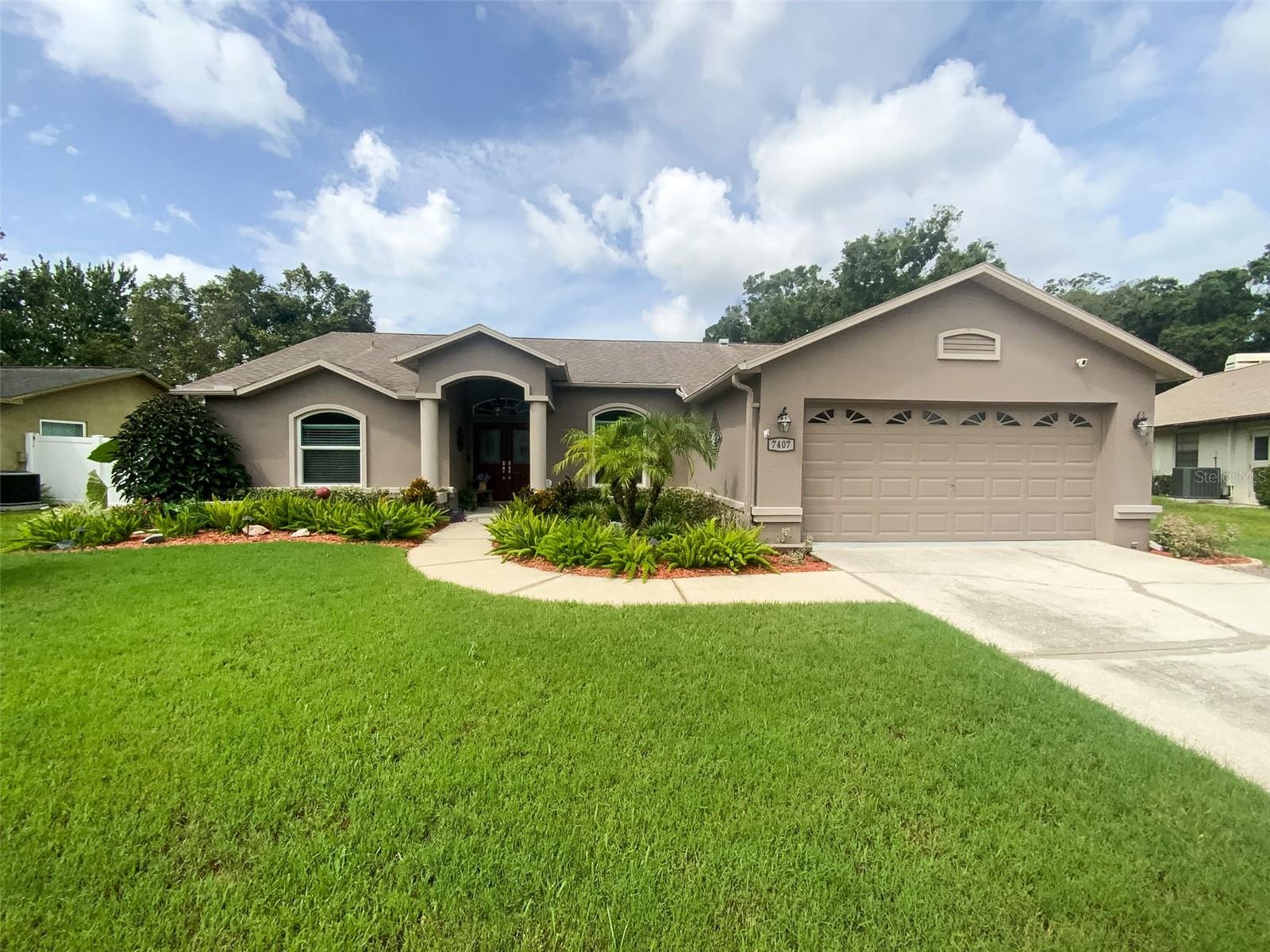 Welcome to this beautiful, newly updated, and meticulously maintained 4-bedroom, 2-bath, 2-car garage pool home in the desirable Glen at River Ridge community! This move-in-ready home sits on a quiet street and offers 1,828 square feet of comfortable living space with impressive curb appeal. From the moment you arrive, you’ll be greeted by lush landscaping and fresh exterior paint. Inside, the bright and welcoming interior features new luxury ceramic tile plank flooring throughout the living areas, elegant light fixtures, and a spacious, open-concept floor plan. The heart of the home is the bright, modern kitchen with ample cabinetry, granite countertops, and brand-new stainless steel appliances—perfect for both everyday meals and entertaining. The open layout seamlessly connects to the generous living and dining areas, creating an ideal space for family and friends to gather. Step outside through the sliding doors to your private oasis: a sparkling pool and patio with breathtaking views of the landscaped backyard. With plenty of room for a grill and patio furniture, this is Florida living at its finest. The thoughtful split floor plan provides excellent privacy. The large primary suite is tucked away on one side and offers direct patio and pool access, along with a luxurious recently renovated primary bath featuring a garden tub, stunning vanity, custom tile work with niche, and high-end fixtures and lighting. On the other side of the home, you’ll find two guest bedrooms, a versatile 4th bedroom that can easily be used as a den, office, or game room, plus a guest bathroom with convenient direct access to the pool area. The roof was replaced in 2015, HVAC replaced in 2021, Exterior home painted 2021, water softener installed 2023, Solar/electric powered 80 gal. hot water heater installed 2015 and stainless steel appliances are brand new within 2 yrs. Conveniently located close to shopping, restaurants, transportation, and the beautiful Gulf Beaches. This turnkey pool home is truly move-in ready and perfectly located for the Florida lifestyle you’ve been looking for. Don’t miss your opportunity to call it yours!