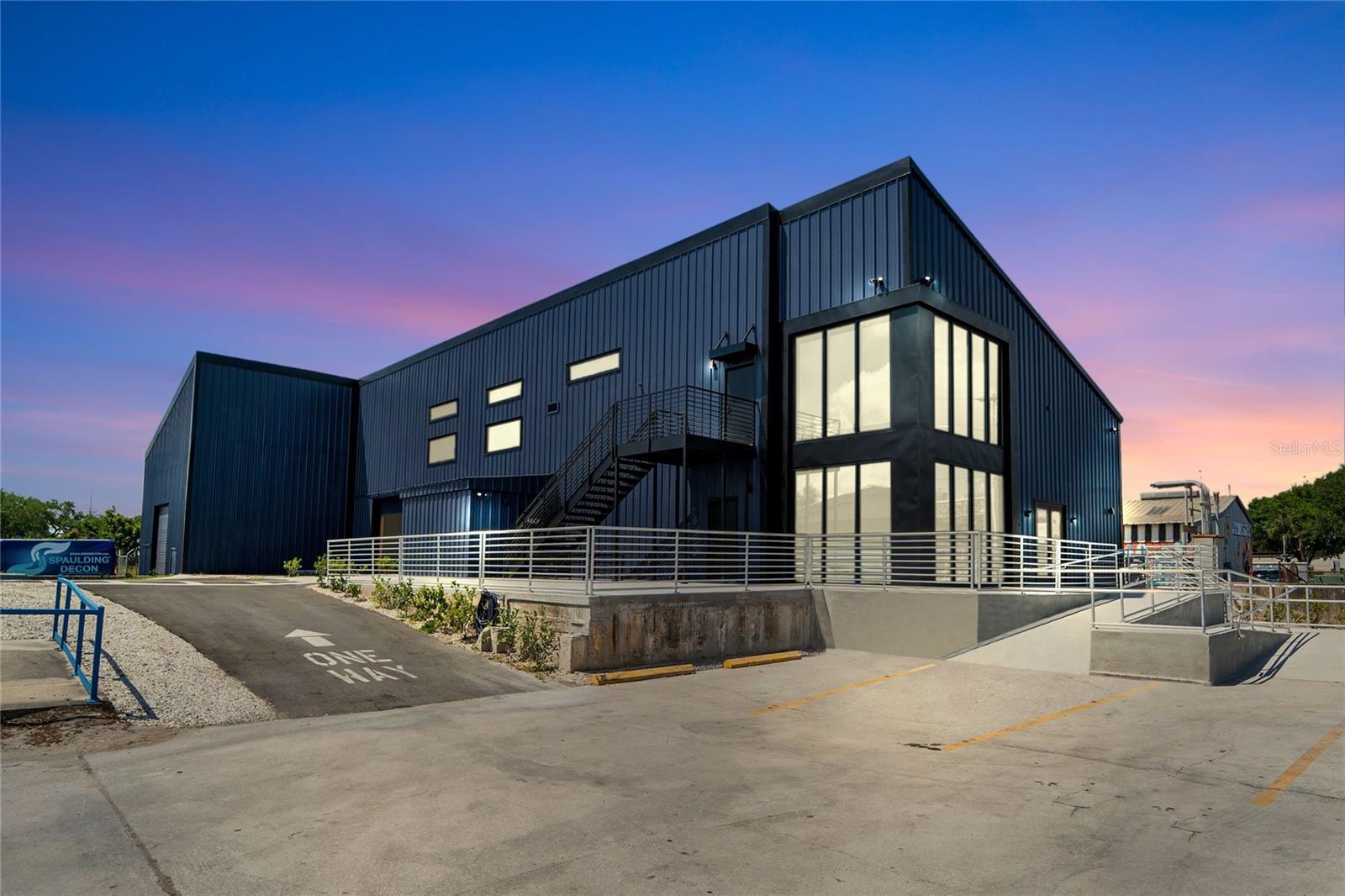 One or more photo(s) has been virtually staged. Florida Commercial Group presents 3605- 3615 E. 7th Avenue.  This property consists of a 4-building portfolio of 5 available spaces.  Ready for occupancy is an oversized warehouse and 2 office buildings, one of which features an adjoined warehouse space.  The entire property has been completely renovated from top to bottom and spans 1.19 acres offering 255’ of direct frontage and signage on east 7th Avenue.  
A rare investment potential or owner/ user opportunity, this property offers many occupancy options: a new owner may occupy both offices and warehouses, or all of the buildings may be leased out individually or as a collective, or the owner may occupy part of the property and lease out the remaining buildings.  The choice is yours. There is plenty of onsite parking and the entire property is fenced.  The IG zoning of this property provides excellent flexibility for distribution, manufacturing, mixed use, a workshop and or storage. 
Included in the purchase of this unique industrial package is Building A: 3,432 SF and currently tenant occupied by a long-standing Bakery tenant.  This tenant signed their NNN lease in 2017 for 15 years with 3% yearly increases.  
Building B offers a move-in ready, oversized, 6k SF newly renovated, high- end office with all the bells and whistles. There is plenty of natural lighting throughout and lots of office suites for staff or private workspaces.  This building features top quality, full renovations to the kitchen and offices.  There is also a gym onsite along with updated restrooms and private showers.  Affixed to this office at the rear of building B is a 1K SF warehouse that may be used in conjunction with the 6k SF office.  
Located at the back of the property and adjoining building B is a 4K SF warehouse considered building C. This building boasts +33’ ceiling heights and 2 grade level roll up doors.  A wide-open layout and is also move-in ready.
Directly across from building C is building D, a fully renovated 2K SF office building that is move-in ready and boasts 3-4 offices, a kitchen/ breakroom and plenty of onsite parking.  The current owner can vacate at the close of purchase allowing an investor to select a new tenant at market rate and terms or to allow for an owner/ user to grow their assets and operate their own facility. Florida Commercial Group can stay on as property manager for the new owner.  Both office buildings are fully furnished.  Call today for a showing and additional details.