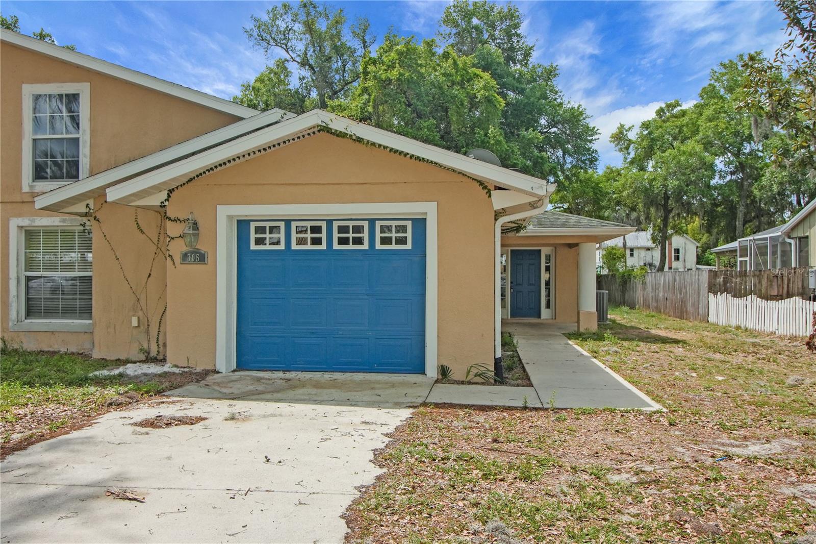Seller is open to helping with closing costs!  Welcome home to this charming 3-bedroom, 2-bathroom half duplex with a 1-car garage, ideally situated in the heart of Fruitland Park. This inviting home features an open floor plan that seamlessly connects the dining and spacious living areas—perfect for both everyday living and entertaining. The kitchen offers ample counter space along with mostly stainless steel appliances, making meal prep a breeze. The primary suite provides a relaxing retreat with a walk-in closet and a private ensuite bathroom complete with dual sinks and a walk-in shower featuring a built-in seat. Step outside to the side porch area—an ideal spot for grilling or unwinding outdoors. Conveniently located near shopping, dining, and everyday amenities, this home combines comfort and accessibility. Schedule your private showing today!