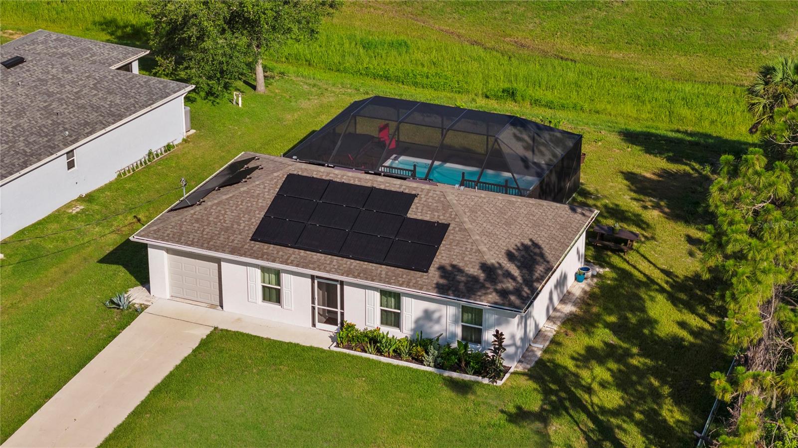 THE ULTIMATE "ZERO COMPROMISE" ESTATE  SOLAR POWERED & FULLY FURNISHED! Why wait for new construction when you can own this meticulously maintained, 2023 BUILT BLOCK MASTERPIECE today? Situated on an OVERSIZED LOT with a dry canal for maximum backyard privacy, this home is a masterclass in luxury and efficiency. Say goodbye to high utility bills with your own SOLAR PANEL SYSTEM, and enjoy the ultimate peace of mind with NO HOA, NO CDD, no rental restrictions, and a location safely nestled in an X FLOOD ZONE (No flood insurance required!). Step inside to an open-concept sanctuary that comes COMPLETELY FURNISHED with high-end, contemporary pieces. The split floor plan ensures total privacy, while the massive living area flows effortlessly to your outdoor oasis featuring a SCREENED IN SALTWATER HEATED POOL, professional landscaping, and a covered lanai perfect for year-round relaxation.
The 2-car garage has been transformed into a fully AIR CONDITIONED MULTI PURPOSE SUITE, perfect for a professional home gym, "Man Cave," or executive office, adding incredible versatility to your daily life. Every detail is handled, from the complete hurricane protection to the lushly landscaped grounds. Located in one of North Port's most serene pockets, you are minutes from the vibrant energy of WELLEN PARK, CoolToday Park, and the mineral-rich waters of Warm Mineral Springs. With rapid access to I-75, US-41, and world-class Gulf beaches, this is Florida living at its absolute finest. Your sunshine retreat is calling schedule your private tour today!