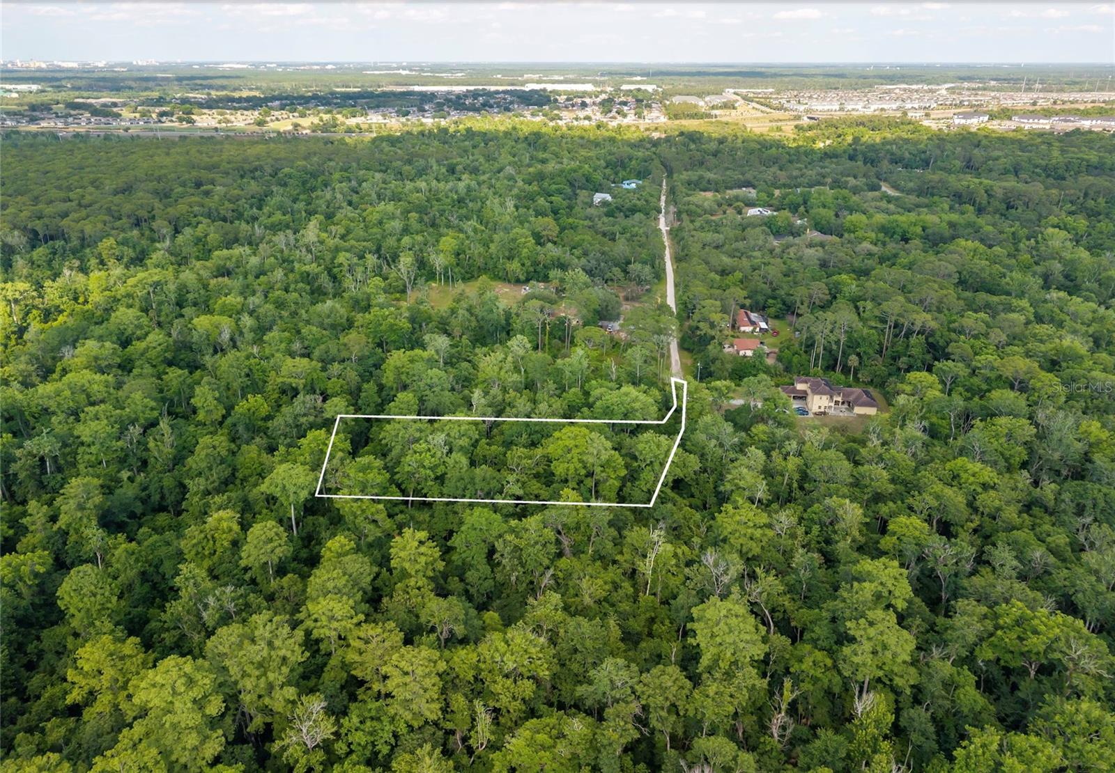 Over 9 acre of land with pure nature to build your dream home. Private and secluded location, country style living yet so close to the city. You must visit Happy Trails community to see the huge mansions that are there. This parcel has two entrances and if you follow Shelley trail side, has a nice home build next to this lot. All theme parks are within 20 minutes drive from this location and so close to Highway I-4. Major chain restaurants and shopping nearby. Best location to call home. Bring your horses, animals and build your dream home, or vacation home. County might allow a multi home as well. Buyer is responsible for survey and due diligence, environment survey and feasibility studies. Heavily wooded but not landlocked. It’s hard to get to this parcel but entrance from Sinclair road is easier and the gate code works from there. There is another parcel next to this one, which is landlocked and only access can be granted from this listed lot. From the 2nd entrance to this lot is where Shelley trail ends and has a house there already, the road ends after this house and leads to this lot.