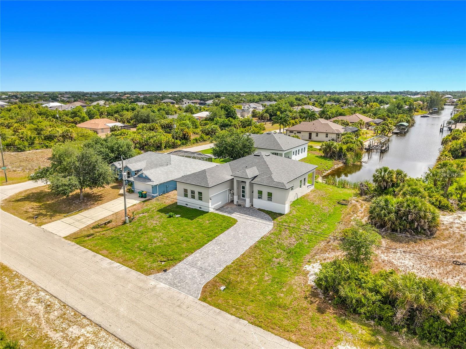 Welcome to your custom waterfront dream home opportunity in the highly desirable South Gulf Cove community of Port Charlotte—where modern design meets the ultimate Florida lifestyle. This thoughtfully designed new construction residence provides over 2,300 sq ft of living space and nearly 3,000 sq ft under roof, blending functionality, elegance, and indoor-outdoor living at its finest. Step through a welcoming foyer into an expansive open-concept great room featuring a spacious family area, formal dining, and a beautifully appointed kitchen—complete with a walk-in pantry perfect for entertaining. The split-bedroom layout ensures privacy, with a luxurious primary suite showcasing dual walk-in closets, a spa-inspired bath with separate shower, and two additional bathrooms, one with direct access to outdoor living. There are also two large bedrooms, plus a flex room ideal for a home office, gym, or guest suite, which provide versatility for today’s lifestyle. Enjoy seamless indoor-outdoor flow through oversized sliding glass doors leading to a covered lanai, ideal for relaxing evenings or future pool plans. The oversized 2-car garage, dedicated laundry room, and abundant storage enhance everyday convenience.
Built to current Florida Building Code standards (2023), this home is engineered for durability and peace of mind, including modern energy efficiency and storm resilience.
Located in the waterfront community of South Gulf Cove, residents enjoy access to over 55 miles of navigable canals, a public boat ramp, parks, and sidewalks, all with a low optional HOA. Just minutes from the pristine beaches of Boca Grande, world-class fishing, golf courses, and the vibrant dining and shopping of Englewood, Port Charlotte and Wellen Park.
This is more than a home—it’s a lifestyle investment in one of Southwest Florida’s fastest-growing waterfront communities.