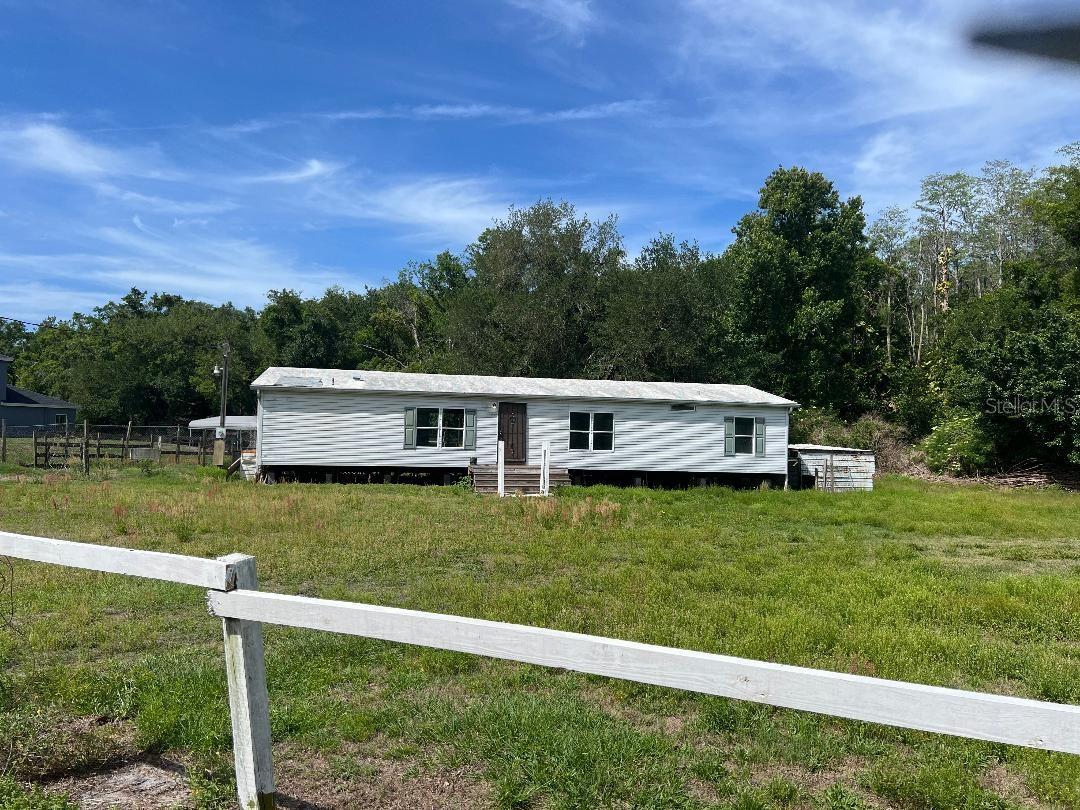 Bring your horses and ATV's! Plenty of room for your boat and RV. Here you have 2.32 Acres in NW Carrollwood Area. 1.81 is zoned AS-1, Agricultural Single Family 1 unit per Acre. There is a creek that runs along the west side of the property for 639 sq ft. It is surrounded by a beautiful mature tree line. Bring your horses, cows, chickens, etc... Two separate pasture areas could be divided into more if needed. The owner is unaware of the property ever flooding. 2 mobile homes on the property along with a barn and an assortment of out buildings. Both mobiles and barn need work, they are currently not habitable. The seller has recently put new carpeting in one of the homes and a new metal roof on the other in 2024. Some flooring work etc. has been done. They could be livable again but would require quite a bit of work. The one mobile is a 3/2 double wide with a large porch. The other is a single wide. The barn has an office or small apartment with room for a kitchen and an existing full bath. Everything needs redo, walls, cabinets, appliances, A/C, etc. There is one well and one septic on sight that will probably require some work. NO sight unseen offers will be accepted. You can NOT see the property from the road. It is a PRIVATE road. Do NOT attempt to view the property without the listing agent as you would be trespassing. Shown by appointment only. More pictures to come soon. AS-1 Can allow
• Agricultural activities, including crop cultivation, small-scale farming, and keeping livestock, subject to county regulations.
• Accessory structures such as barns, sheds, and garages that support residential or agricultural use.
• Certain home-based businesses may be permitted if they comply with county restrictions and do not disrupt the rural character.