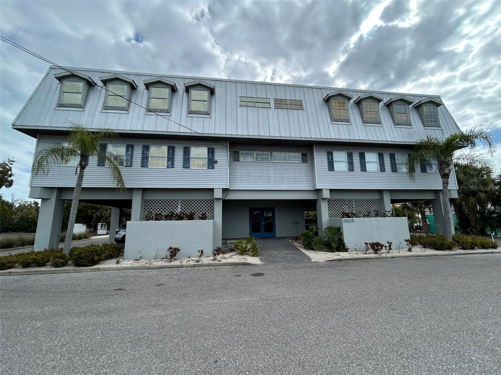 Rare office space available in well established commercial building in the heart of Holmes Beach on Anna Maria Island. The office area resides in a commercial condominium equipped with elevator, a public restroom for men and women on the second and third floors.  Unit for sale is on the second floor. Sign space available and one parking spot under the building.  Plenty of exterior parking with both a street and back door entrance. Building provides diverse occupants of financial planning, medical offices, and construction. Current layout of the 988 square feet is a break room with galley kitchen with updated kitchen cabinets.  Furthermore, there are three (3) areas equipped with desk counters accommodating several office spaces as well as one room that contains shelving for miscellaneous storage. Interior is decorated coastal with ship lap walls and large doors with glass. Perfect for a small-medium professional office. Space is directly off the main commercial thoroughfare running North and South on Anna Maria Island. This is the hub of Anna Maria Island with Publix, CVS, Walgreens as well as the largest shopping area on Anna Maria Island all an orange throw across the street.  This is a perfect location to service residents and visitors of Anna Maria Island. Owner financing will be considered, act now!