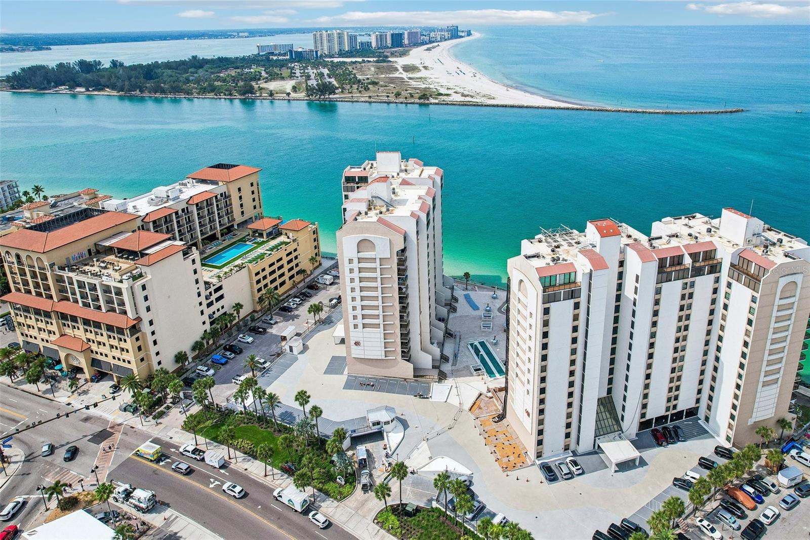 Experience the ultimate coastal lifestyle in this direct Gulf-front condo offering expansive water views and breathtaking sunsets. This highly sought-after, 1,186-square-foot residence features two bedrooms, two bathrooms, and a large private balcony perfect for watching boats cross the sparkling blue waters. The interior features a bright great room layout ideal for entertaining, complemented by a kitchen with a closet pantry and breakfast bar seating. The primary suite serves as a private retreat, complete with dual closets and an en-suite bathroom featuring a walk-in shower, double vanities, and a linen closet. Additional conveniences include an in-unit stackable washer and dryer, plus a dedicated storage room located directly across the hall (shared with only three other residents on the floor). The monthly association fees cover water, sewer, trash, cable, internet, building amenities, and 24/7 guarded security. For investors or seasonal residents, the community permits short-term rentals (30-day minimum), offering an excellent opportunity to generate income and offset ownership costs. Property Note: The complex is currently undergoing extensive building updates and repairs. Perfectly situated within walking distance of world-renowned Clearwater Beach, premier dining, shopping, and vibrant coastal activities, this property delivers a perpetual vacation experience.