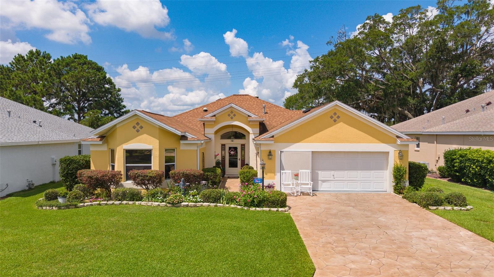 BOND PAID! Welcome to this beautifully maintained Designer Lantana nestled on one of the most picturesque homesites in The Villages. Perfectly positioned along the Nancy Lopez Championship Golf Course, FRONTAGE ON THE FAIRWAY OF HOLE #2, this exceptional property offers breathtaking golf and water views framed by majestic oak trees draped in Spanish moss.

From the moment you step through the front door, you'll be captivated by the home's bright, open layout and stunning panoramic views. Abundant solar tubes and skylights fill the living spaces with natural light, creating a warm and inviting atmosphere throughout. The spacious floor plan features generously sized bedrooms, soaring ceilings, and an effortless flow that's perfect for both everyday living and entertaining.

The heart of the home is the well-appointed kitchen, complete with granite countertops, stainless steel appliances, and a desirable butler's pantry providing additional storage and workspace. The expansive lanai serves as a true outdoor living room, offering the perfect place to enjoy morning coffee, evening sunsets, or simply relax while watching golfers play against the backdrop of the tranquil pond.

Additional highlights include a newer roof (2018), HVAC system (2024), whole-house water filtration system (2024), reverse osmosis drinking water system (2024), irrigation system (2025), luxury vinyl flooring in the bedrooms, tile throughout the main living areas, an oversized garage (25x24/26) (with offset 13x2) and abundant storage, and a freshly painted interior.  Call your trusted agent today and get your private tour scheduled.