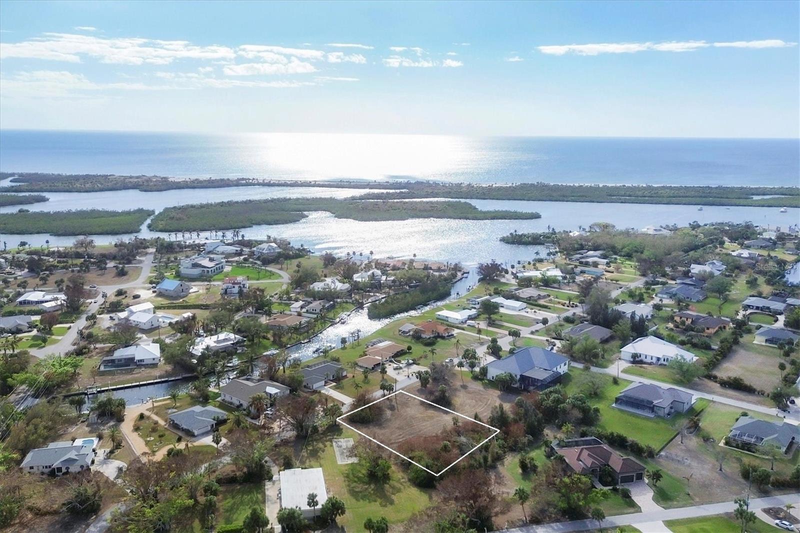 Nestled in the heart of historic Placida, this spacious 0.57-acre lot offers a rare opportunity to build your dream home in one of Southwest Florida’s most charming and timeless coastal communities. Located within a quiet, well-established neighborhood that borders the Intracoastal Waterway, the property combines natural beauty, historical character, and relaxed coastal living. Although the lot itself is not directly on the water, it enjoys close proximity to marinas, public boat ramps, and stunning Intracoastal views, placing world-class boating, fishing, and island-hopping adventures right at your fingertips. The neighborhood is known for its canopy of mature oaks, palms and iconic banyan trees, creating a lush, shaded setting that reflects the authentic spirit of Old Florida. Classic cottages, winding streets, and native landscaping make this a truly unique place to call home. With 0.57 acres of land, there's plenty of space to design a custom home, tropical garden, pool, or even a detached garage or guest suite. The property is located in a community with a voluntary HOA, offering the benefits of a well-kept neighborhood without the burden of mandatory fees. Just minutes away, you’ll find Boca Grande, Gasparilla Island, golf courses, beaches, nature preserves, and local restaurants—all contributing to the area’s laid-back, coastal lifestyle. This is a rare opportunity to own land in one of Placida’s most sought-after and storied neighborhoods. Build your legacy beneath the banyan trees, where history, nature, and the Intracoastal come together in perfect harmony. We can provide builder references as well.