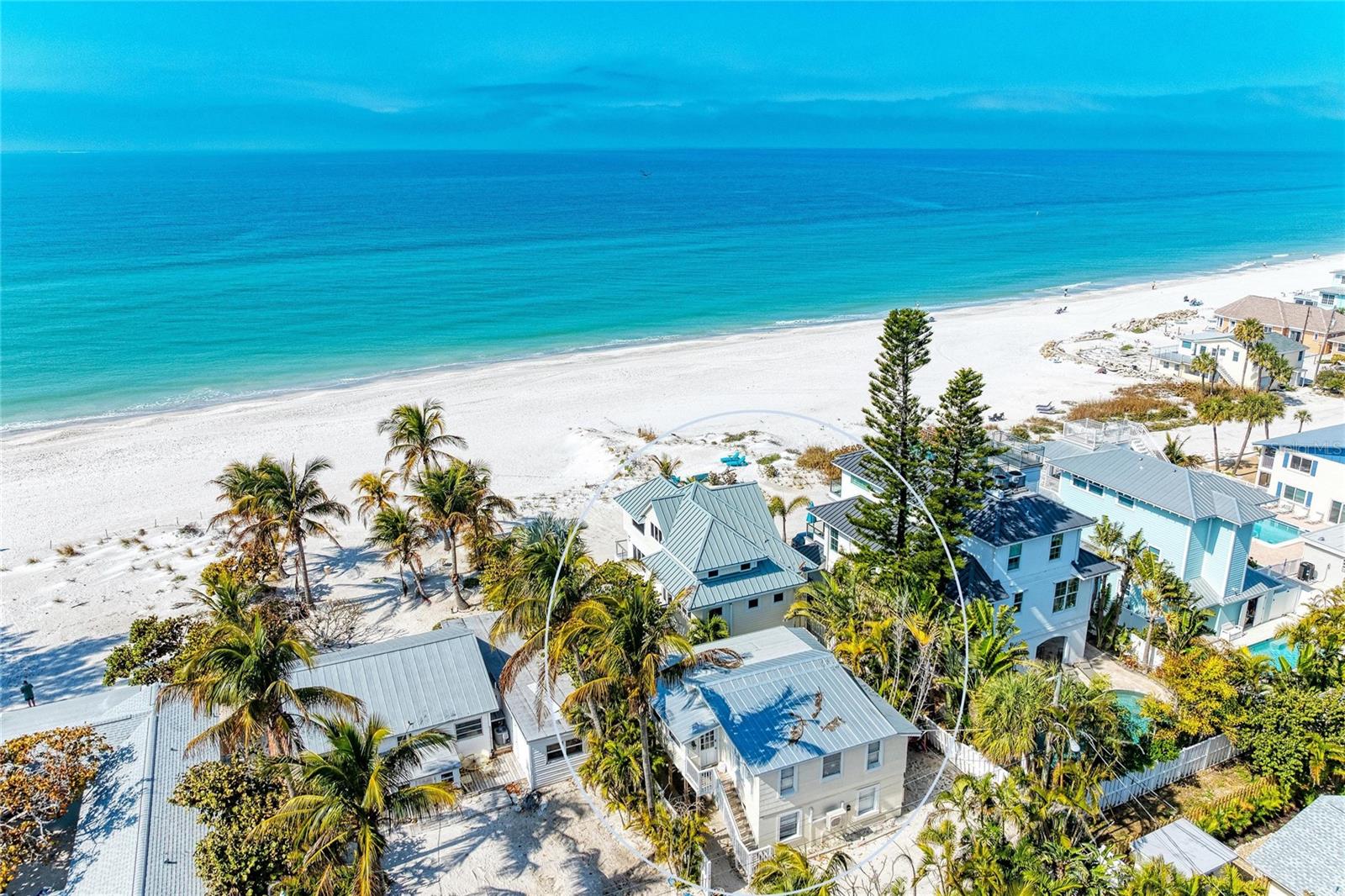 One or more photo(s) has been virtually staged. Beachfront property on the sugary sands of Anna Maria Island! Experience the pinnacle of waterfront living with majestic sunsets and breathtaking Gulf views. This beachfront property offers two separate structures and is zoned as a Land-Condominium with ability to have four separate condominium units. Being sold turnkey, the beachside house offers a total of four bedrooms and four baths and can be divided into two separate condominium units. The downstairs two bedrooms, two baths are ideal for guests and family for space and privacy. The bottom floor was recently repaired and updated due to damage from Hurricane Helene. The upstairs unit is in mint condition and outfitted with cathedral ceilings, laminate floors, granite kitchen counters and stainless steel appliances. The living area provides panoramic Gulf views and opens up to the exterior balcony to enjoy grilling out and listening to the sound of crashing waves to help take away all your worries. The back house has two separate units, upstairs and downstairs, which are ideal for additional guest and rental income. The upstairs and downstairs units are being rented and have a full schedule for potential future rental reservations. Each turnkey unit offers two bedrooms and one bath. This property offers so many opportunities to make it your own. With 50-by-100 feet of non-buildable lot owned by the seller, the property offers its private beach access. It's all about the view, the beach, the aqua blue waters and sunsets. This property is being sold as three parcels. Schedule your showing today to see this amazing property.