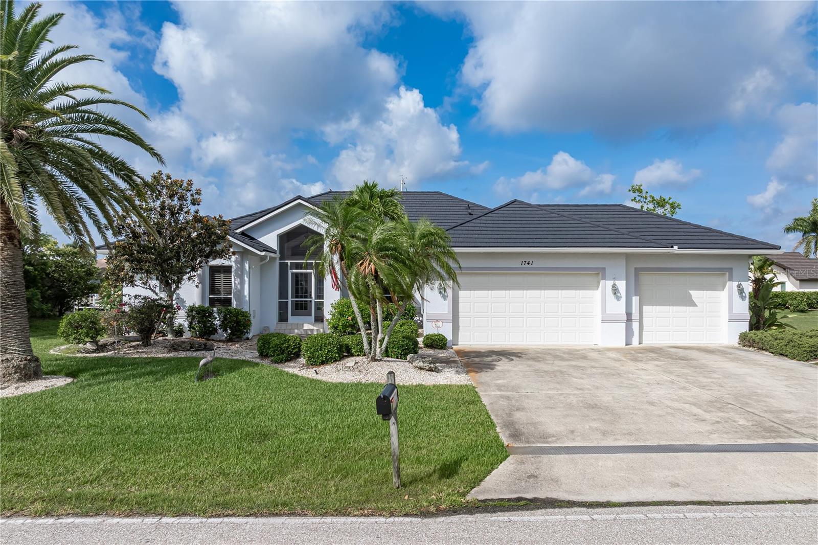 PGI WATERFRONT HOME W/SAILBOAT ACCESS, NEW METAL ROOF (2024) & 3-CAR GARAGE - A sailboat docked in your backyard, sunsets painting the canal each evening, and a new metal roof overhead. This 3 bed/2.5 bath waterfront home in Punta Gorda Isles delivers where it counts. With 2,285 sq ft of living space, a 3-car garage, screened pool, and a 45-ft concrete dock along a sailboat-access canal, the only thing left to do is move in. Boaters will appreciate the deep-water sailboat access to Charlotte Harbor. Reach open water in approximately 15-20 minutes from your private dock. The 45-ft concrete dock is equipped with water and electric hookups, a dock light, and a working davit. Keep your boat just steps from the back door. Inside, the layout gives you real separation between living spaces. A formal living room and dining room greet you at entry, while the family room at the back of the home features soaring cathedral ceilings, built-in shelving, and large, impact-resistant windows that flood the space with natural light. The kitchen sits at the heart of the home. It features updated, stainless steel appliances, a breakfast bar, and built-in recipe desk. The adjacent breakfast area features a mitered glass, aquarium window that looks directly out to the pool and canal view. The split bedroom floor plan keeps owners and guests comfortable. The master suite has walk-out access to the lanai, two walk-in closets plus a large master bath with dual sinks, a corner soaking tub, and a separate shower. Guest bedrooms are well-sized with ample closet space. They share a hall bath. Disappearing sliding glass doors in the living room and family room open to the lanai extending the living space outdoors. The lanai features a large covered seating area that overlooks the in-ground pool. Southwestern rear exposure means colorful sunsets over the canal. Lots of updates including a NEW metal tile roof (2024), NEW refrigerator (2024), NEW dishwasher (2025), NEW washer (2024), NEW dryer (2023), and NEW water heater (2026). The 3-car garage offers serious storage and flex space, with room for vehicles, gear, a golf cart, or a dedicated workshop area. St Andrews South Golf Course is just minutes away. Miles of sidewalks out front connect you to the rest of Punta Gorda Isles. Head out on foot, by bicycle or drive to nearby Fishermen's Village, Isles Yacht Club, or historic downtown Punta Gorda. Discover why Punta Gorda is often cited as one of the best small towns in Florida. Additional benefit of PGI is the fact that the City of Punta Gorda maintains the seawalls and canals, a significant long-term benefit for any waterfront owner here. Claim your spot in paradise. Make an appointment today.