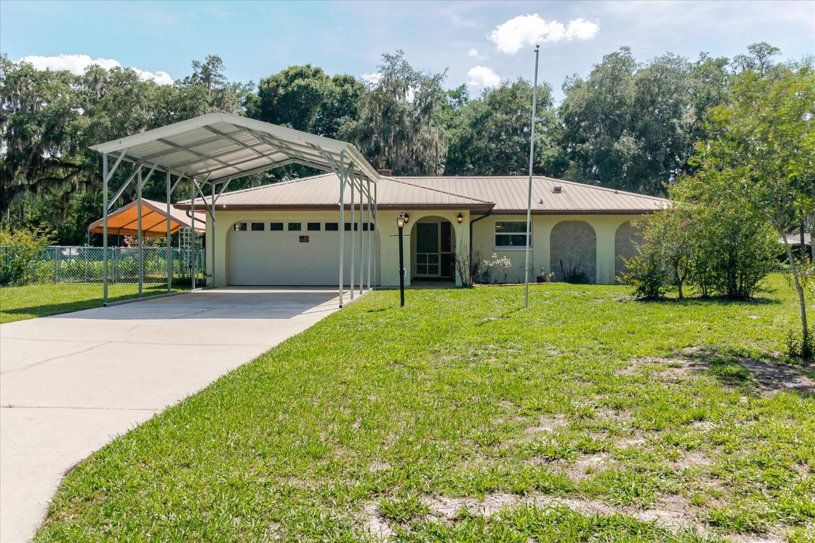 BACK ON THE MARKET DUE TO A BUYER ISSUE! Welcome to your own slice of waterfront paradise on highly sought-after Gospel Island. Nestled beneath majestic grandfather oaks on a beautifully landscaped 0.42-acre lot, this charming 2-bedroom, 2-bath home offers 90 feet of freshwater canal frontage with direct access to Lake Henderson and the Tsala Apopka Chain of Lakes, one of Citrus County's premier destinations for boating, fishing, kayaking, and waterfront recreation.

Inside, you'll find 1,301 square feet of comfortable living space featuring a spacious split-bedroom floor plan, luxury vinyl plank flooring, a cozy wood-burning fireplace, French doors, and abundant natural light. Recent improvements provide peace of mind, including a metal roof (2013), AC (2019), garage door (2022), water heater (2025), and new carpet (2025).

Step outside and enjoy the Florida lifestyle you've been dreaming of. Relax on the covered porch overlooking the water, watch breathtaking sunsets paint the sky, or launch your next adventure from your own backyard. The property also features mature landscaping, storage shed, additional shed or "she-shed" and ample outdoor space for entertaining, gardening, or simply enjoying the peaceful surroundings.

Located just minutes from historic downtown Inverness, you'll enjoy convenient access to local restaurants, shopping, medical facilities, parks, golf courses, festivals, and the Withlacoochee State Trail while still enjoying the privacy and tranquility of waterfront living.

Whether you're searching for a full-time residence, seasonal getaway, retirement retreat, or investment opportunity, this home offers a rare combination of waterfront access, privacy, character, and location. Best of all, there is no HOA. Don't miss this opportunity to own a piece of the Florida lifestyle in one of Inverness's most desirable waterfront communities.