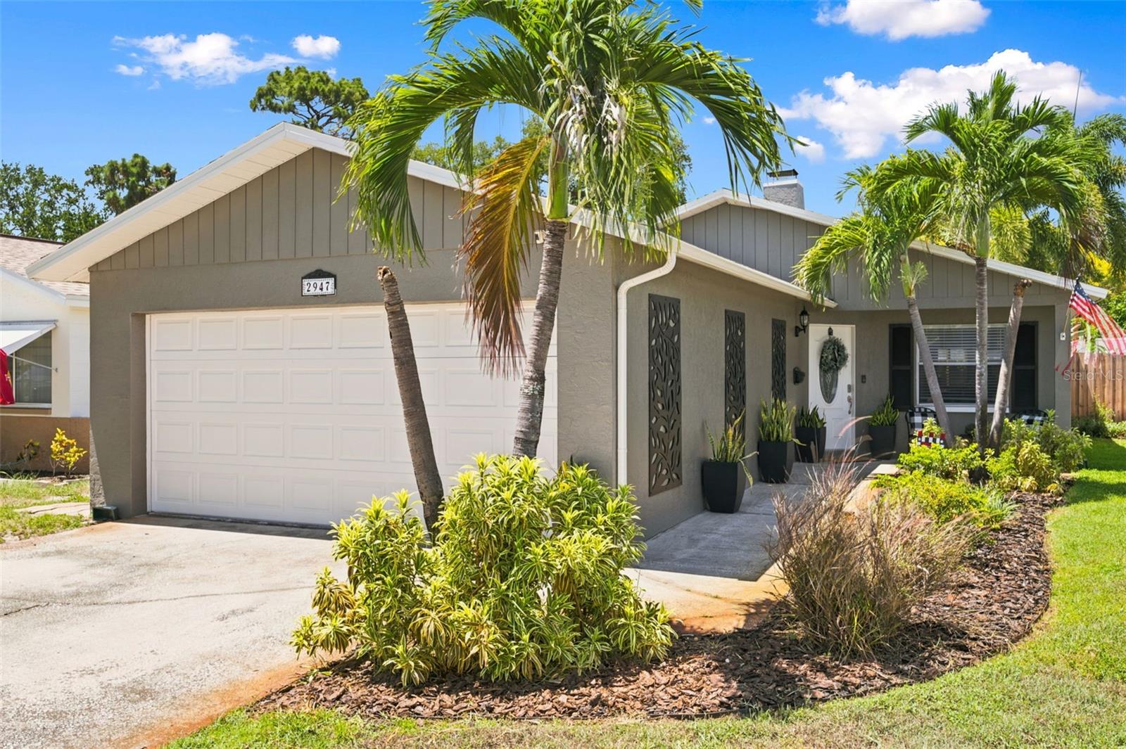 Welcome home to this charming, turnkey 3-bedroom, 2-bath residence ideally located in one of St. Petersburg's most desirable neighborhoods! Freshly painted inside and out, this beautifully maintained home offers a warm and inviting atmosphere with wood-look tile flooring throughout and a cozy, functional floor plan that seamlessly blends the living room, dining area, and kitchen.
The heart of the home features a stunning stone wood-burning fireplace, creating the perfect focal point for gatherings and cozy evenings at home. The kitchen is thoughtfully designed with white cabinetry, granite countertops, newer stainless-steel appliances, and convenient access to the sunroom through a double-pane, hurricane-rated sliding glass door that fills the space with natural light while providing seamless indoor-outdoor living.
The primary suite provides a private retreat with an en-suite bathroom, walk-in closet, and direct access to the rear sunroom. Two additional bedrooms are filled with natural light and share the hall bathroom.
One of the standout features of this property is the spacious rear sunroom, offering additional living space and serving as the perfect transition to the incredible backyard oasis. Step outside and discover an entertainer's dream, complete with a raised deck and gazebo, a gravel firepit conversation area, professional landscaping, outdoor lighting, a storage shed, and a fully fenced yard that provides both privacy and charm. Whether hosting friends and family or simply enjoying a quiet evening outdoors, this backyard is designed to impress.
Additional updates and highlights include a roof that's only one year old and an updated electrical panel with whole-home surge protection.  The property has experienced no flood damage and no hurricane damage, offering added peace of mind for future homeowners.
A rare find for the area, the home also boasts a spacious 2-car garage—an amenity not commonly found in many St. Petersburg neighborhoods.
Conveniently located just minutes from award-winning Gulf beaches, major interstate access for commuters, downtown St. Petersburg attractions, and the renowned Mazzaro's Italian Market, this home offers the perfect blend of comfort, convenience, and Florida living.
Don't miss your opportunity to own this meticulously maintained St. Petersburg gem! **NO flood insurance required, and NO HOA.**