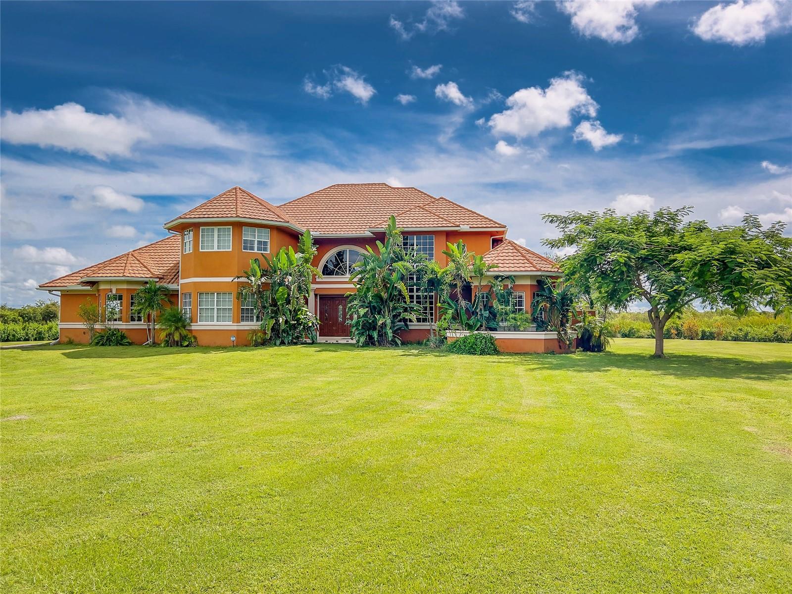 Luxury waterfront multi-family estate offering breathtaking, unspoiled views where every detail was intentional. This extraordinary private compound features a custom-built 7,181 sq. ft. main residence with 4 en-suites, pool bath, & half bath along with a separate 3/3 guest house with a 6-car garage. Situated on private acreage with its own gated driveway, private boat ramp, & dock. Built to withstand CAT 5 hurricanes, CBS construction, metal roof, high elevation, no flood insurance required. The luxurious dual primary suites include custom closets, separate his-and-her vanities, rain showers, and Jacuzzis. Interior finishes include travertine, marble, onyx, and wood flooring throughout. The gourmet chef’s kitchen is appointed with Brookwood cabinetry, “jeweled” granite countertops, double sinks, double ovens, bread warmer, gas cooktop island, breakfast nook, wine room, oversized walk-in pantry, and an expansive great room with a custom bar designed for entertaining. Additional features include plantation shutters, wraparound waterfront verandas, private upstairs balconies, elevator shaft, Icynene insulation for energy efficiency whole-house security system. Surrounded by pristine Florida ecosystem and abundant birdlife, the property offers miles of interconnected waterways leading to the Peace River and Charlotte Harbor. Underground utilities allow for helicopter or seaplane landing and storage. Located across from F-13 Airport & only 10 miles from Punta Gorda Airport.