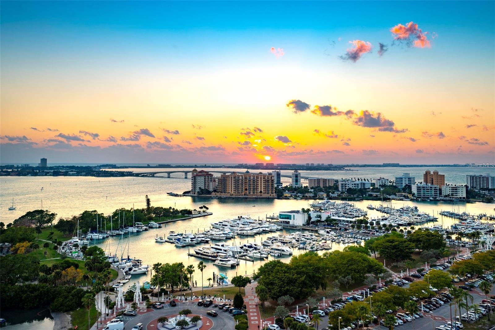 Step into The Mark, the pinnacle of luxury living in Downtown Sarasota. Feels brand new, this 12th-floor penthouse a state-of-the-art retreat offering unparalleled comfort, breathtaking views, and immediate occupancy. From the moment you enter, expansive vistas of Sarasota Bay and the vibrant downtown skyline captivate the senses. Designed for an elevated lifestyle, the open floor plan has been further enhanced by the removal of walls, creating an airy, seamless flow that feels both expansive and inviting a true home in the sky. With three spacious bedrooms, each boasting a private en-suite bath, plus an additional powder room, this penthouse is perfect for both privacy and entertaining. The chefs kitchen is a masterpiece, featuring sleek European cabinetry, an induction range, a large island with additional seating and refrigeration drawers, and a direct connection to the terrace making indoor-outdoor living effortless. Yet, what truly sets this residence apart is its exceptional outdoor living space, the best of any unit in the building. The west-facing, oversized balcony spans the length of the residence, offering breathtaking sunset views over Sarasota Bay the perfect setting for morning coffee or evening gatherings. The outdoor kitchen, complete with an electric grill and beverage center, transforms this space into an entertainers dream. Practicality meets luxury with a storage locker conveniently located down the hall, two side-by-side assigned parking spaces in the covered garage, and available EV charging stations. Built in 2019 by Kolter/Kast to the latest building codes, The Mark offers peace of mind with hurricane impact windows, 24/7 security, and concierge services. Experience resort-style living with an incredible rooftop pool, spa, cabanas, a bar, grilling area, and a fire pit. The state-of-the-art amenities level includes one of Sarasotas top fitness centers, a spin room, a club room with a catering kitchen and bar, a meeting room, a media lounge, and billiards. Downstairs, enjoy exclusive retail shopping and services, with fine dining, Whole Foods, and boutique shops just steps away. Located minutes from Siesta and Lido Key beaches, St. Armands Circle, cultural venues, and the Sarasota Bayfront, this extraordinary penthouse offers the ultimate blend of luxury, convenience, and lifestyle. With its unrivaled outdoor space, exceptional design, and premier location, this is truly one of the most valuable and exclusive residences Sarasota has to offer.