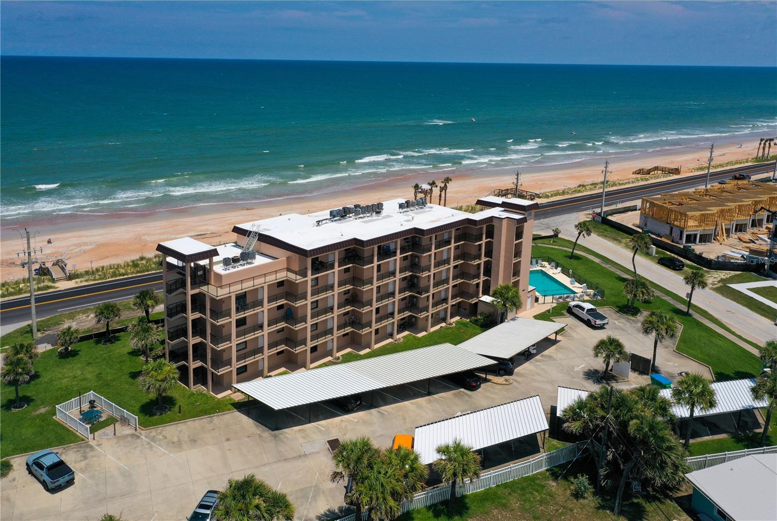 Wake up to the sights and sounds of the Atlantic Ocean from this first-floor condominium. Situated within a five-story oceanfront building, this residence offers the perfect blend of convenience and coastal living. Enjoy the ease of first-floor access while still taking advantage of the building's prime oceanfront location. Whether you're looking for a full-time residence, seasonal getaway, or investment opportunity, this condominium provides an exceptional beachside lifestyle. Inside, you'll appreciate the convenience of an in-unit laundry, making everyday living effortless. A covered, assigned parking space offers protection from the elements and added convenience year-round. Spend your days strolling the sandy beach, watching spectacular sunrises over the Atlantic, or simply relaxing while enjoying the refreshing ocean breezes. Ideally located along scenic Ocean Shore Boulevard, you'll be just minutes from local restaurants, shopping, golf courses, parks, and all that Ormond Beach and nearby Daytona Beach