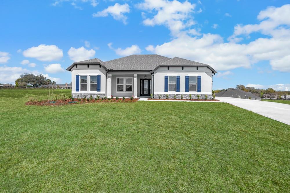 Introducing the Albany at Saddle Hill by Terrata Homes – Fruitland Park

Welcome to the Albany, a thoughtfully designed four-bedroom, two-bath home located in the brand-new Saddle Hill community in Fruitland Park. From the moment you step inside, the home welcomes you with a sense of balance and openness. A central foyer creates the ideal entry point, guiding you into a spacious family room that anchors the entire home.

The open-concept layout seamlessly connects the kitchen, dining, and family room, creating a comfortable and inviting space for both everyday living and entertaining. The kitchen overlooks the family room and features a large center island, quartz countertops, bright white cabinetry, stainless steel appliances, a modern tile backsplash, and matte black hardware. The adjacent dining room offers a cozy yet open setting for family dinners and celebrations.



Sliding glass doors lead to the expansive covered outdoor kitchen, extending your living space outdoors and creating the perfect setting for relaxing evenings or entertaining guests. A welcoming covered front porch adds even more charm and curb appeal.

The private owner’s suite is tucked into the back corner of the home, offering a quiet retreat away from the main living areas. Generously sized and filled with natural light, the bedroom provides a peaceful place to unwind. The spa-inspired bathroom features a soaking tub, walk-in shower, dual vanities, and a spacious walk-in closet designed for both comfort and convenience. Secondary bedrooms are located along separate hallways, creating natural separation between living and resting spaces.

Additional features include luxury vinyl plank flooring throughout the main living areas, upgraded lighting and plumbing fixtures, refined trim details, blinds throughout the home, a separate laundry room, and a two-car garage. Every detail has been thoughtfully selected to deliver a polished, move-in-ready home with no upgrades required.

Saddle Hill is nestled among the quiet, tree-lined landscapes of Fruitland Park, offering a peaceful setting while still being close to everything you need. Just minutes away, enjoy the scenic shores of Lake Griffin, beautiful golf courses, charming local cafés, boutiques, restaurants, farmers markets, art walks, and live music events. Here, small-town charm meets thoughtfully elevated living.

Book an appointment and experience this beautiful new community for yourself.