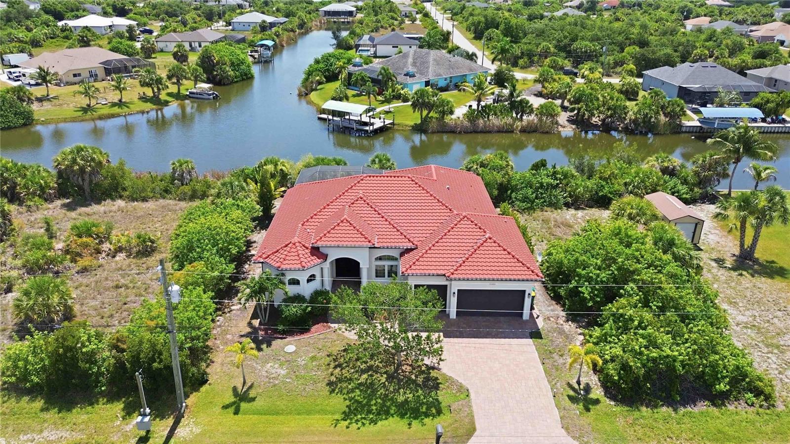 A rare opportunity to own a truly turnkey luxury waterfront home in South Gulf Cove! Built in 2017, this custom-designed 3-bedroom, 2-bath residence with a spacious loft, oversized 3-car garage, and approximately 2,400 sq. ft. of living space showcases exceptional craftsmanship and premium finishes throughout.

The open floor plan features soaring ceilings, a stunning coffered ceiling in the great room, 8-foot interior doors, custom trim work, designer lighting and plumbing fixtures, and a chef's kitchen with custom cabinetry and high-end appliances. Every detail reflects quality construction and pride of ownership.

Perfectly positioned on a private canal with beautiful water views, this home offers direct access to deep water with no bridges—ideal for boating and fishing enthusiasts. Enjoy Florida living year-round from the screened lanai featuring a heated pool, fully equipped outdoor kitchen with built-in gas grill, and generous entertaining space overlooking the water. A private wooden dock completes this exceptional waterfront setting.

What truly makes this property one of a kind is that it is being offered completely furnished and equipped. Virtually everything you see is included: designer furniture, décor, TVs, kitchenware, premium appliances, bed linens, bath linens, outdoor furniture, gym equipment, pool table, and even two newer electric bikes with fewer than 500 miles each. Simply bring your suitcase and start enjoying the Florida lifestyle on day one.

Whether you're searching for a primary residence, a vacation getaway, or a high-end short-term rental investment, this home is ready to enjoy immediately with no additional expense. Luxury waterfront homes of this caliber, offered completely turnkey, are exceptionally rare. Don't miss your chance to own one of South Gulf Cove's finest properties!