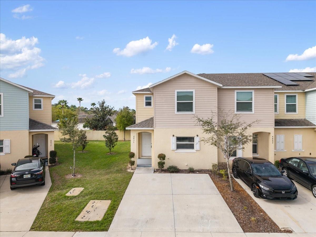 Welcome to 4855 Coral Castle Drive, a beautiful corner-unit townhome located in the gated community of Fiesta Key. This spacious two-story home features an open and inviting floor plan with a large living and dining area that flows seamlessly into the kitchen, complete with stainless steel appliances, a breakfast bar, and plenty of cabinet space—perfect for entertaining family and friends. Enjoy relaxing evenings on the screened patio with added privacy thanks to the desirable corner location. Upstairs, the primary suite offers dual closets and a private bathroom with dual vanities, while two additional bedrooms and an upstairs laundry room provide comfort and convenience for everyday living. Fiesta Key offers resort-style amenities including a clubhouse, fitness center, tennis courts, and community pools, with the HOA covering lawn maintenance, gated security, and more for low-maintenance living. Conveniently located just minutes from Disney, 5 minutes drive from train station, shopping, restaurants, hospitals, and major highways, this property is ideal as a primary residence, vacation home, or investment property. Schedule your private showing today and come see everything this home and community have to offer.