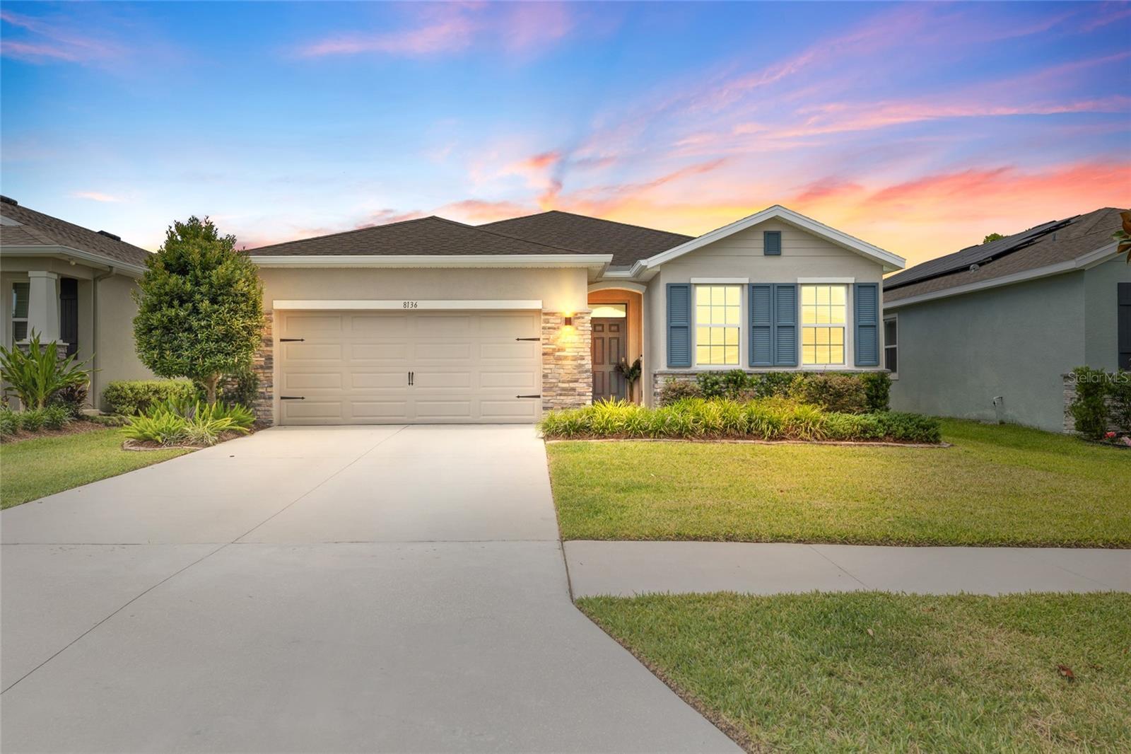 Why wait to build when you can own the larger, upgraded version today? This beautifully maintained, original-owner 2021 D.R. Horton home offers 2,048 sq ft of thoughtfully designed living space with features that are no longer standard in many of the builder's current floor plans—including soaring high ceilings, granite countertops throughout, and a much larger screened lanai. Located in the desirable gated Abbott Park community of Zephyrhills, this exceptional home also features 4 bedrooms, 2 bathrooms, a 2-car garage, and a highly desirable split-bedroom floor plan that combines comfort, privacy, and modern style. Exceptional curb appeal begins with a stacked stone exterior, lush professional landscaping, decorative shutters, and an inviting covered portico entry. Inside, durable tile flooring flows throughout the main living areas, complemented by ceiling fans, recessed lighting, and an open, airy floor plan. A Ring® doorbell conveys with the home. Two spacious secondary bedrooms are located at the front of the home, each featuring standard closets and convenient access to a full guest bath with a granite vanity, undermount sink, and tiled tub/shower combination. Two hallway linen closets provide abundant storage. The heart of the home is the beautifully appointed kitchen featuring stainless steel appliances, granite countertops, crown-molded cabinetry, a stylish tile backsplash, recessed lighting, a walk-in pantry, breakfast bar with counter-height seating, and a sunny eat-in dining area. The spacious family room features a custom board-and-batten accent wall and sliding glass doors that open to the screened lanai, creating a seamless indoor-outdoor living experience that's perfect for entertaining. Step outside to relax while overlooking the fully fenced backyard, surrounded by lush greenery with plenty of space for pets, play, or gardening. The private owner's suite offers a peaceful retreat with a ceiling fan, two closets, and a well-appointed ensuite bath featuring dual granite vanities, an oversized tiled walk-in shower with a built-in bench, shampoo niche, and a private water closet. Additional highlights include a generously sized laundry room with LG washer and dryer that conveys, plus space to add a utility sink. Residents of Abbott Park enjoy outstanding community amenities including a resort-style swimming pool, clubhouse, playground, dog park, and scenic walking trails. Conveniently located just minutes from SR 54, US Highway 301, and Morris Bridge Road, the community offers quick access to Interstate 75, making commuting to Tampa, Wesley Chapel, Lakeland, and Tampa International Airport a breeze. You'll also enjoy being close to shopping, restaurants, medical facilities, entertainment, golf courses, and the Shops at Wiregrass, Tampa Premium Outlets, and AdventHealth Zephyrhills. Well cared for and move-in ready, this exceptional home combines modern design, quality finishes, and an unbeatable location — schedule your private showing today.