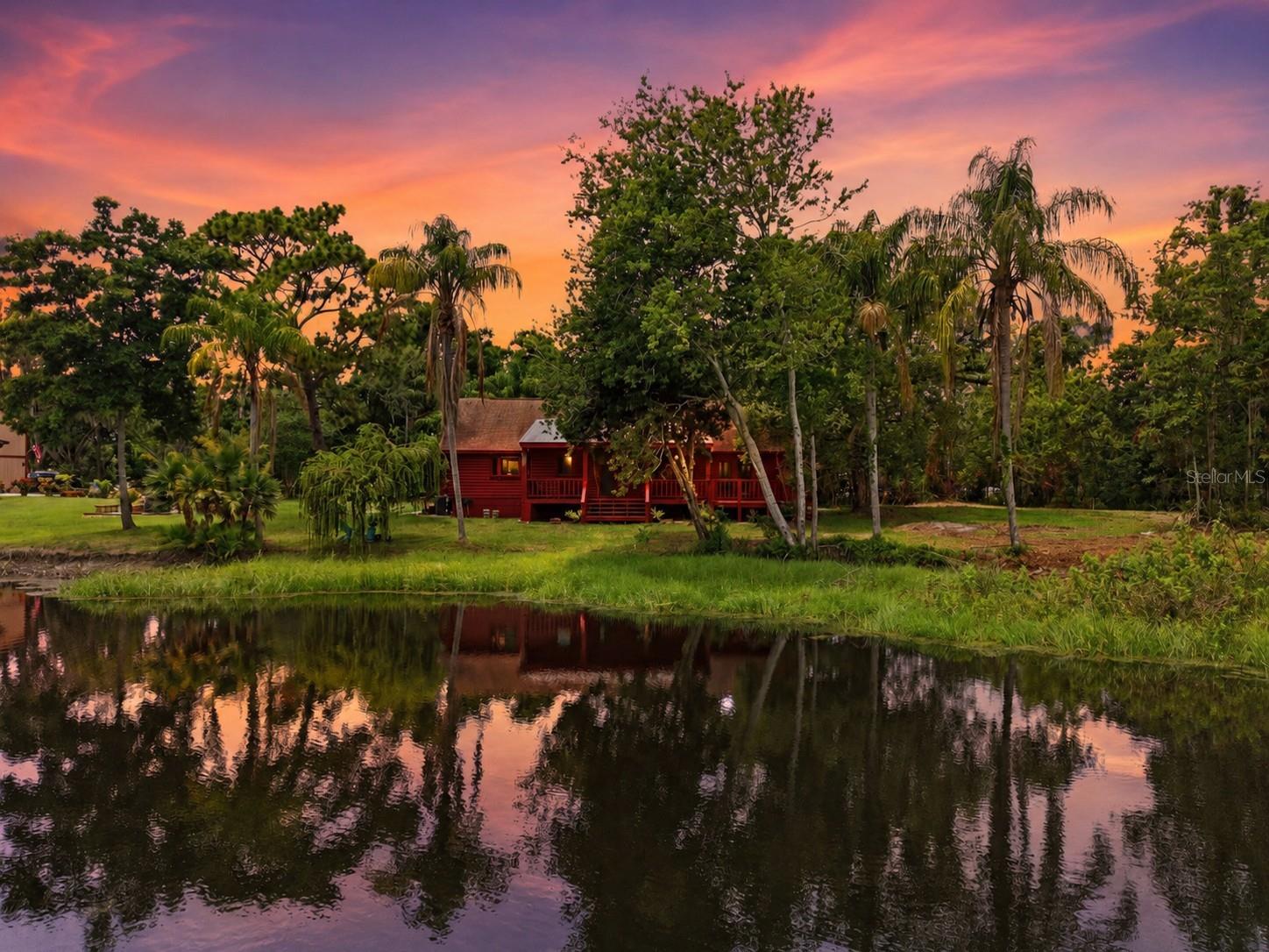 Rare opportunity to own 2.23 acres of buildable lakefront land in the highly desirable Oak Ridge community of New Port Richey. Situated on a beautiful spring-fed lake with over 500 feet of shoreline, this unique property offers a blend of privacy, natural beauty, and future potential that is increasingly difficult to find.

Mature trees and established landscaping create a peaceful setting, while multiple pastures and open areas provide flexibility for a variety of uses. The property features an existing cedar cabin, along with electric service, a private well, and septic system already in place. With portions of the property located in X flood zone, there are opportunities to build a custom waterfront estate while utilizing the existing cabin during the construction process.

The ER zoning allows for up to three grazing animals, making this an attractive option for those seeking a small hobby farm, private retreat, or luxury lakefront homesite. Enjoy breathtaking sunrises over the water, abundant wildlife, and a healthy lake stocked with fish, all from your own backyard.

Oak Ridge is an established community known for its spacious homesites, with every residence situated on over an acre. This property stands out with more than double the typical lot size, extensive lake frontage, and exceptional privacy. Whether you're looking to build your dream home, create a family compound, or simply enjoy the serenity of waterfront living, opportunities like this are few and far between.