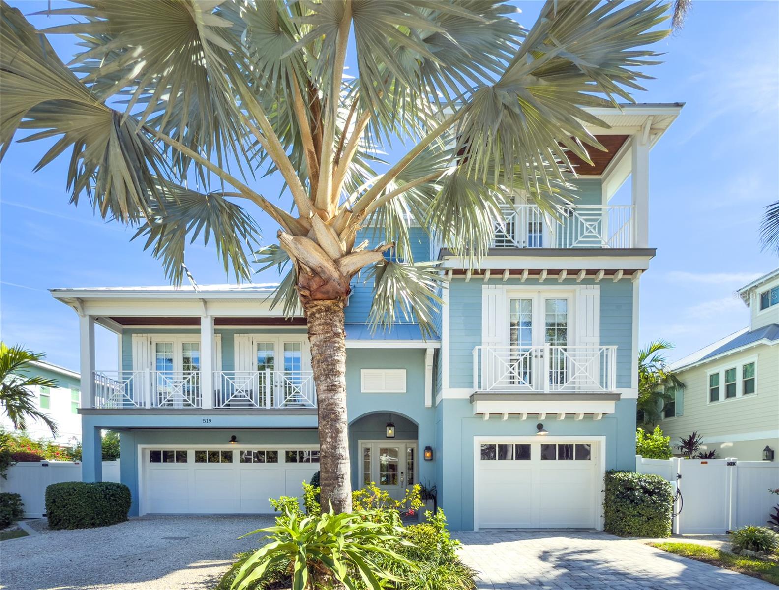 This stunning property, situated on the premier private street of Anna Maria, was designed for the perfect blend of island indoor living and outdoor entertaining. Completed in 2017, this 3385sq ft open-plan luxury home has over 2000 SQ FT OF EXTERIOR PORCHES (6 porches). The ROOFTOP LOOKOUT DECK has expansive views extending from Tampa Bay to the Gulf of Mexico beaches. The outdoor movie deck, with the wonderful backdrop of the Skyway Bridge, makes a family movie-night an event to remember.
This home has extensive access to a navigable canal with direct entry (no bridges) to Tampa Bay and the Gulf, via beautiful Bimini Bay, where the local dolphins love to gather. The main dock has a modern seawall, a 15,000LB CANTILEVERED BOAT LIFT and composite decking, including lights, electric pedestal, and fresh water. Alongside is a matching 18 ft floating dock for ease of use with kayaks or wave runners. Whether you enjoy fishing, boating, or just sitting along the waters edge in the evening this property blends your onshore life with the endless water possiblities.
The rear garden area is extensively landscaped for privacy. The large pool has a tanning ledge that can accommodate lounge chairs and umbrellas . There is a matching hot tub incorporated into the elegant outdoor layout that is located in the shade. When you’ve finished with swimming and sunbathing, why not continue the fun on the 3-HOLE PUTTING GREEN. Adults will enjoy the TIKI BAR and outdoor entertaining area. There is a boating/fishing storeroom, a full bathroom, and a laundry room so wet towels, swimming suits and fishing clothes will not be hauled into the main home. 
The interior boasts an open floor plan that provides for abundant natural light. Whether you're hosting a family get-together, cocktail party, or just relaxing in this coastal paradise, you can enjoy the tranquillity of the layout. All levels are served by an elevator for ease of access.  Most of the rooms enjoy decks or porches, with attractive views of the waterfront or of the quiet neighbourhood. The main living floor is comprised of a gourmet chef's kitchen, outfitted with professional-grade appliances, extensive countertops and custom cabinetry. Adjacent to the kitchen, there is a butlers pantry laundry room and prep kitchen. Walls of high-impact sliding glass doors blur the lines between indoors and out, framing breathtaking panoramic views. The thoughtful design and natural textures—from the luxury flooring to the elegant finishes—ensure a comfortable space where every detail is in tune with the island lifestyle. Separate from the living area is a large den that can serve as an office workspace with access to a relaxing porch. The floor plan on the middle level is completed by two large bedrooms.  On the upper-level is the expansive master suite, where you can retreat to your own personal sanctuary and private porch area. There is a generous walk-in closet and a luxurious master bathroom. The front-facing guest suite is spacious with a walk-in closet and a modern stylish bathroom. It also has its own private sitting porch.
There is a double and a single garage with epoxy flooring. The home was designed with the environment in mind with an economical geothermal heating and cooling system for both the living spaces and the pool/ spa. There are fast electric car charges in the driveway and in the garages on seperate electric circuits. For your saftey, the whole house has Hurricane Impact window and doors.