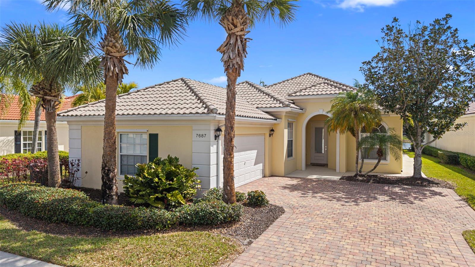 Seller offering 15,000. towards Buyer's closing costs. Welcome to the sought-after Oakmont model in the vibrant community of VillageWalk—perfect for buyers ready to embrace an active, resort-style lifestyle. This meticulously maintained 3-bedroom, 2-bath home with a den offers an open floor plan enhanced by soaring 10- and 12-foot ceilings, creating a light, bright interior with a relaxed coastal feel. The spacious kitchen features granite countertops, a closet pantry, and flows seamlessly into the main living areas, which are finished with tile flooring for easy living. The primary suite is a private retreat with an ensuite bath and abundant closet space, including a generous walk-in closet. Two additional bedrooms and a versatile den provide flexibility for guests or a home office. Step outside to your screened lanai overlooking tranquil water views—an ideal setting for morning coffee or evening gatherings with friends. Additional highlights include a dedicated laundry room with upper cabinets and a utility sink, plus a two-car garage with convenient attic storage. Built by DiVosta Homes using poured reinforced concrete construction, this home offers lasting quality and peace of mind. Residents of VillageWalk enjoy beautifully landscaped grounds with scenic lakes, charming bridges, and tree-lined streets. Amenities are second to none, including a resort-style pool and lap pool (both geothermal heated), state-of-the-art fitness center, six Har-Tru lit tennis courts, pickleball, bocce, and basketball courts. The community also features a restaurant and tiki bar, gas station, hair salon, boutique, and a full calendar of activities coordinated onsite making it easy to connect and make friends.
With a reasonable HOA fee covering lawn maintenance and irrigation, plus a 24-hour manned guard gate, this community offers both convenience and security. Ideally located near Siesta Key, Legacy Trail, Costco, Publix, as well as shopping, dining, medical facilities, and the arts—this home truly has it all.