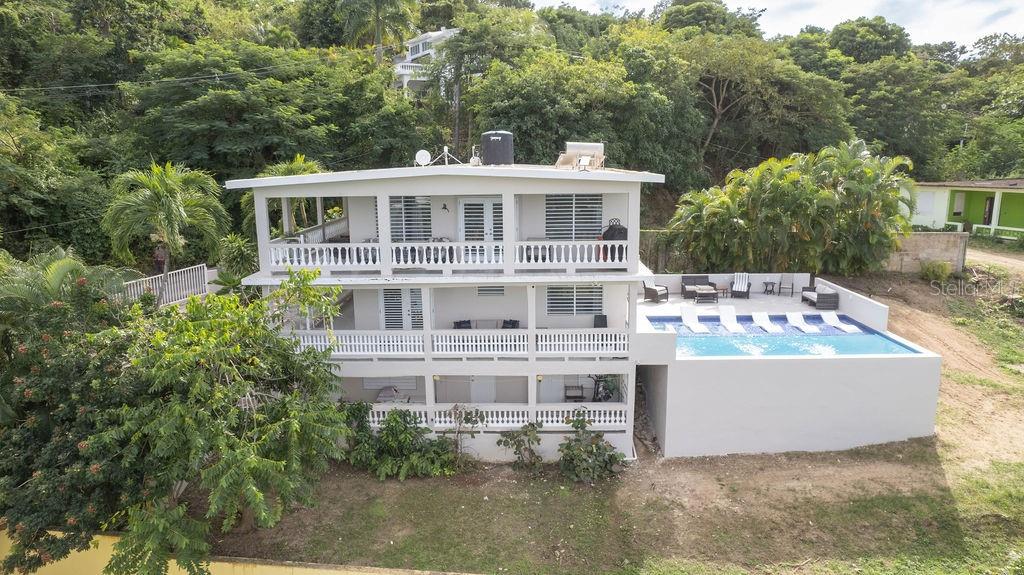 Mar Vista is nestled into the hillside in the Los Chivos neighborhood on Vieques Island and has extraordinary views of the North coast including Culebra Island, Cayo Blanco and the main island of Puerto Rico.

Mar Vista is a classic Caribbean style villa with three bedrooms and two bathrooms on two levels and surrounded by lush tropical gardens and a stunning, new swimming pool.

Under new ownership many changes have been made including beautiful new bathroom renovations, , new windows, new mini-split air conditioners , new interior doors, new ceiling fans, new furniture, removal of trees to enhance the views and new equipment. This is a must see!

The top level has the primary bedroom and bathroom both being very spacious. The bathroom is newly renovated with beautiful concrete counters, contemporary fixtures and contemporary tiles. The upper level with primary bedroom is the main gathering area with a large open concept living area featuring panoramic ocean views from inside as well as from the oversized wrap around balconies. The very large kitchen is functional and has contemporary kitchen cabinets and beautiful granite counter tops. The cook top has six burners and is gas.

The middle level of the home is connected by a stairway and is completely self contained second unit. There are two guest rooms sharing newly renovated bathroom. The home has a generous open floor plan with kitchen, living room and dining area all sweeping out to large outdoor balconies. The brand new swimming pool is easily accessed from this level of the home. There is a large storage area, craft room or shop on this level as well.

The lower level of the home features a laundry room and two ample owner's storage spaces.

The home has secure off street parking and beautiful mature tropical landscaping. All three bedrooms have mini split air conditioning systems, security systems and the home is sold turn key furnished.

The home features a back up water cistern and a solar hot water heater and an electric back-up generator.

Mar Vista is surrounded by tropical gardens and sweeping ocean views. There are beautiful palm trees, succulents, colorful Bougainvillea and Heliconia, ferns and many other delights.