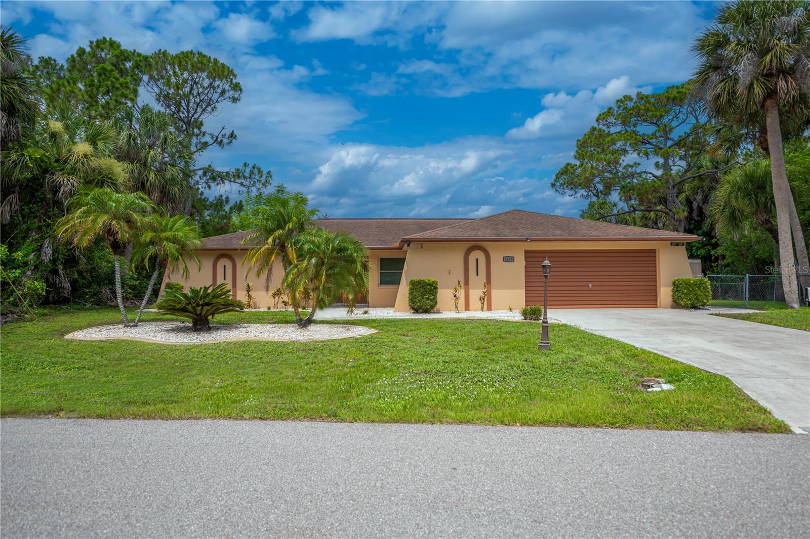 Welcome to this exceptional 3-bedroom, 2-bath waterfront pool home, perfectly positioned on an oversized 0.29-acre lot in the heart of Port Charlotte. With 120 feet of saltwater canal frontage along the Auburn Waterway, this home offers direct boating access to Charlotte Harbor and the Gulf of Mexico, making it a true paradise for boating and waterfront enthusiasts.
Offering 2,053 square feet of thoughtfully designed living space, the home features a desirable open floor plan that blends comfort, functionality, and modern style. The main living area is bright and inviting with tile flooring and expansive sliding glass doors that open seamlessly to the screened pool and lanai, creating the perfect setting for indoor-outdoor living and entertaining. A dedicated dining area sits just off the living room, ideal for gatherings.
The spacious kitchen is well appointed with solid-surface countertops, tile backsplash, stainless steel appliances, a breakfast bar, pantry, and abundant cabinetry, all overlooking the welcoming family room. Rich in character, the family room showcases a beamed ceiling and a striking wood-burning fireplace with stone surround, along with additional sliders that extend the living space outdoors.
The primary suite offers a peaceful retreat with private pool access, a walk-in closet, and a beautifully updated ensuite bathroom featuring dual vessel sinks, a natural stone countertop, brushed-nickel fixtures, and a walk-in shower with contemporary tile and glass enclosure. Two additional generously sized bedrooms share a conveniently located guest bathroom, providing comfortable accommodations for family or guests.
This home has been thoughtfully updated with numerous interior enhancements designed for comfort, functionality, and modern living. Updates include fresh interior paint throughout; replacement of all electrical outlets, switches, and cover plates; additional wiring and recessed (can) lighting in multiple rooms and hallways; and new switches and wiring installed for ceiling fans. Travertine flooring, along with new baseboards and trim, has been installed in two bedrooms, and all closet doors have been upgraded to wood and glass. Interior door hardware, hinges, door pulls, and drawer pulls have been replaced throughout for a cohesive, updated look.
The kitchen features new recessed and pendant lighting, a new faucet, and a new garbage disposal. The fully remodeled laundry room includes new cabinetry and lighting, along with a new Samsung stackable washer and dryer. Additional interior upgrades include new ceiling fans in bedrooms, the living room, family room, and bathroom; new lighting in bedroom closets; replaced room-to-room vent covers; fitness room flooring; window blinds in most rooms; and a cabinet added above the primary bathroom toilet.
Step outside to your own private waterfront oasis, complete with a screened-in pool, canal views, and a large dock with boat lift poles in place—perfect for enjoying Florida’s coastal lifestyle year-round. Additional highlights include an insulated, air-conditioned bonus room off the garage (ideal for a home office, studio, or flex space), impact windows, newer roof, A/C, water heater, storage shed, and Fiberon dock.
Located in a quiet, established neighborhood just minutes from Port Charlotte Beach Park, shopping, dining, medical facilities, US-41, and I-75, this move-in-ready home offers the very best of Florida waterfront living.