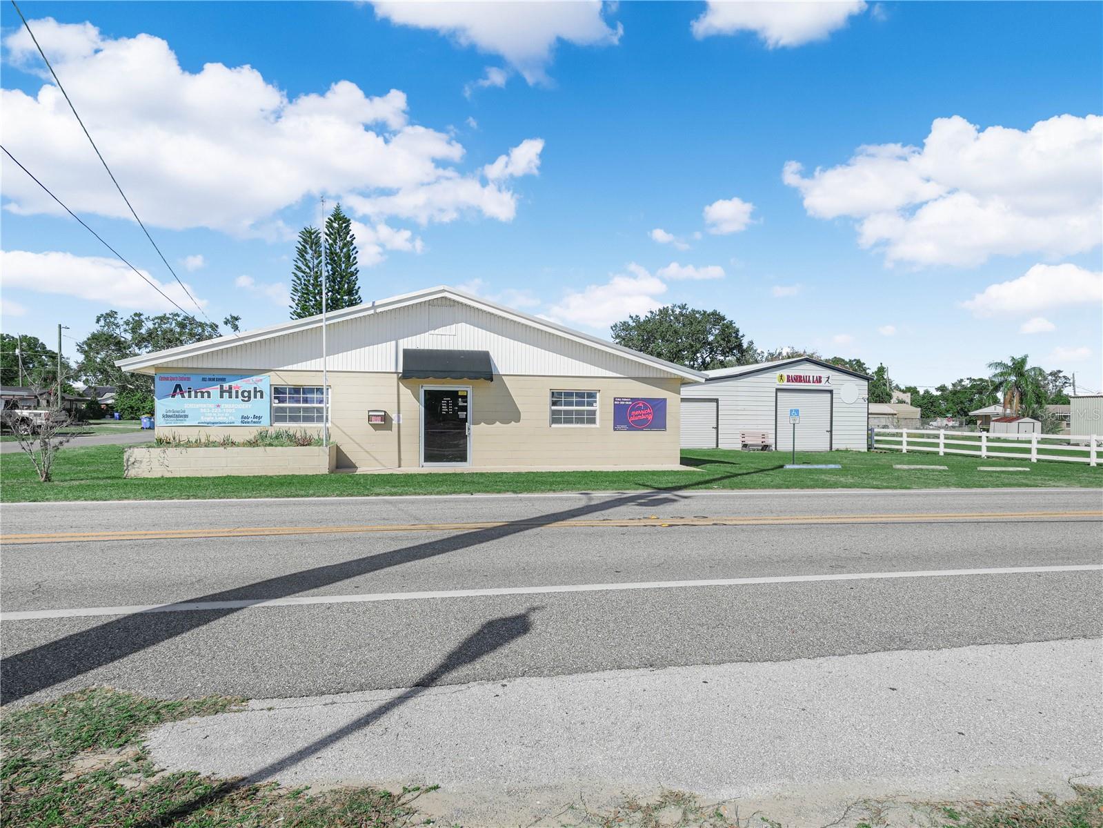 Located in the heart of Polk County within the growing town of Eagle Lake, this ±5,349 SF commercial property presents a compelling opportunity for both investors and owner-users.

The site includes a 2,300 SF air-conditioned retail building, currently partially owner-occupied and partially leased to a tenant through April 2026, along with an ±280 SF storage shed. At the rear of the property is a 2,769 SF non–air-conditioned structure with a gravel floor, presently leased on a month-to-month basis to a sports/baseball training facility.

Situated just one street off State Road 17, and separated only by a railroad, the property benefits from strong visibility and exposure, with the potential for prominent signage subject to approvals. State Road 17 carries an average daily traffic count of approximately 14,500 vehicles, providing excellent access and market presence.

The property is zoned General Commercial, allowing for a wide range of potential uses in accordance with the town’s land use table and conditional approval requirements.
This offering is well suited for an investor seeking redevelopment potential or an owner-user desiring a highly visible, centrally located, and easily accessible commercial site.