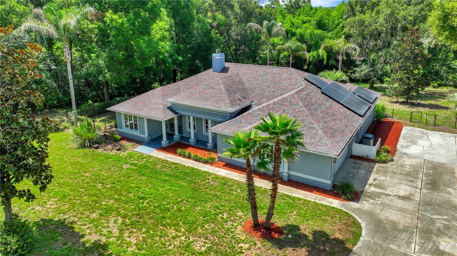 Welcome to this beautifully maintained 4-bedroom, 3-bath single-family home offering 2,684 square feet of thoughtfully designed living space on a spacious 1.5-acre homesite (approximately 76' x 292'). The open, split-bedroom floor plan is enhanced by soaring cathedral ceilings, elegant 8-foot interior doors, and an impressive three-sided fireplace that creates a warm focal point between the main living areas.  The well appointed kitchen features rich cherry cabinetry, stunning quartz countertops, and ample workspace, making it ideal for both everyday living and entertaining.  Tile and wood flooring flow throughout the home, adding timeless style and easy maintenance.  Step outside to enjoy the expansive outdoor living spaces, including a finished 820 sq.ft screened aluminum porch and a huge bi-level trek deck (2019) overlooking the fully enclosed backyard.  Additional upgrades provide exceptional value and peace of mind, including a new roof installed at the end of 2022, a 56 panel solar energy system installed in 2023 w/ an average electric bill of just $25.00 a month, a Trane HVAC system in 2018, and new septic drain field installed in 2021.  Completing this exceptional property is an oversized garage with an additional parking pad, offering plenty of room for vehicles, storage, or recreational equipment.  Combining quality upgrades, energy efficiency, generous indoor and outdoor living spaces, and a desirable layout, this move-in-ready home is an outstanding opportunity for buyers seeking comfort, functionality, and long-term value.