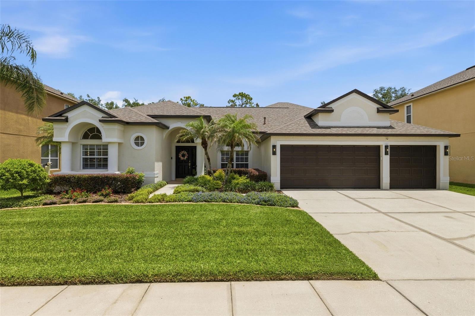 Welcome to the kind of home that immediately captivates! Where soaring ceilings, open spaces, and walls of sliding glass doors create a bright, airy atmosphere that feels both luxurious and livable. Perfectly positioned on a large private lot with no rear neighbors in the gated Seven Oaks community of Brookforest, this sprawling home offers the ideal Florida layout designed for both seamless entertaining and everyday comfort.

Natural light pours into every space, highlighting the home’s refined finishes, magazine worthy styling, and meticulous attention to detail. Plantation shutters, custom accent walls, crown molding, wide baseboards, soaring ceilings, custom closets, and newer luxury vinyl flooring all contribute to the home’s sophisticated, yet, welcoming feel.

At the heart of the home, the gourmet kitchen is both stunning and functional, featuring quartz countertops, an oversized bar, convenient island, 42 inch cabinetry, a gas range, wine refrigerator, commercial ice maker, and new refrigerator, all seamlessly connected to the main living spaces. A signature seamless bay window overlooking the lanai beautifully enhances the space, creating an airy architectural focal point while drawing the outdoors in. Offering both formal and casual dining areas, as well as formal and family rooms, the floorplan provides exceptional versatility while maintaining an open, cohesive flow.

The split bedroom layout creates privacy for the primary sanctuary, complete with space for a sitting area and a recently renovated spa inspired bath that feels straight from a luxury resort. Upstairs, a rare and highly desirable second ensuite offers its own spacious living area, bedroom, and bath, ideal for guests, multigenerational living, or a secluded hideaway.

Outdoor living is truly exceptional. The expansive screened lanai is designed for year round enjoyment and features a fully equipped outdoor kitchen with generous storage, refrigerator, sink, grill, and even a kegerator, while the Big Green Egg also conveys with the home. The lush St. Augustine lawn, large backyard, and peaceful privacy with no rear neighbors create an outdoor setting that feels like your own serene resort.

This meticulously maintained home has been thoughtfully updated with a 2021 roof, brand new gas water heater, and numerous additional upgrades throughout its 12 years of ownership. A spacious three car garage completes the package.

Residents of Brookforest enjoy the privacy of a gated neighborhood with two private parks, along with walkable access to the renowned Seven Oaks clubhouse & amenities, including resort style pools, waterslide, fitness center, tennis courts, pickleball, basketball, sand volleyball courts, café, movie theater, walking trails, playgrounds, and event spaces. Beyond the gates, Seven Oaks is widely considered one of Wesley Chapel’s most ideally positioned communities, tucked within a convenient “triangle” between major roadways and just minutes from multiple interstate access points, making daily commuting, dining, shopping, and travel remarkably convenient while still feeling established, residential, and beautifully maintained.

Homes with this level of design, care, functionality, and style, especially offering TWO true ensuites, are exceptionally rare. Every inch of this residence reflects owners with an impeccable eye for detail and a true appreciation for refined living.