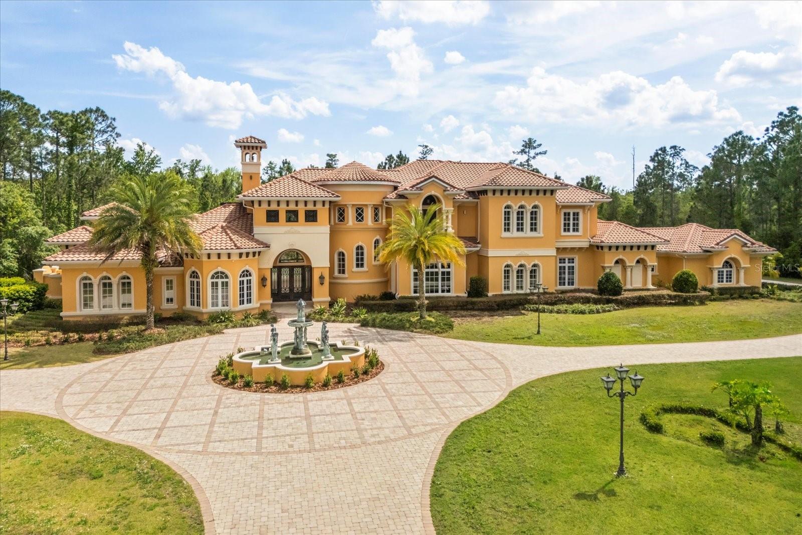 Welcome to a truly unparalleled luxury estate, nestled on 5 acres of serene privacy. This custom-built masterpiece, completed in 2009, boasts an impressive 11,138 square feet of meticulously designed living space, where every detail has been thoughtfully curated for the discerning homeowner.

As you enter through the private gate, you are greeted by a stunning family room featuring a handcrafted stone gas fireplace and soaring ceilings that create an inviting atmosphere. The elegant curving marble staircase, adorned with a magnificent Swarovski crystal chandelier, sets the tone for the opulence that awaits.

This estate offers 5 spacious bedrooms, each with large walk-in closets and en-suite bathrooms, ensuring comfort and privacy for family and guests alike. The main living areas are enhanced by exquisite woodwork, including a gorgeous dining room and a living room that seamlessly connects to the outdoor oasis through sliding glass doors that open at the corner, perfect for entertaining.

Indulge in the ultimate entertainment experience in the media room, complete with luxurious seating and a stunning chandelier commissioned from Tiffany's in New York. The primary suite is a true retreat, featuring a cozy sitting area and an expansive closet. Additional highlights include a gym with a steam room, an office/study/library, and an upstairs game room that overlooks a spacious covered balcony.

The outdoor amenities are equally impressive, featuring a large pool with a spa, ample undercover seating, an outdoor kitchen, and tennis courts, all surrounded by lush landscaping and majestic oak trees. The estate also includes a wine cellar, a wet bar with custom woodwork, and coffered ceilings adorned with unique prints.

With a 4-car side garage and an attention to detail that is truly one of a kind, this estate is unlike anything you have ever seen. Experience luxury living at its finest—schedule your private tour today and discover the extraordinary lifestyle that awaits you.