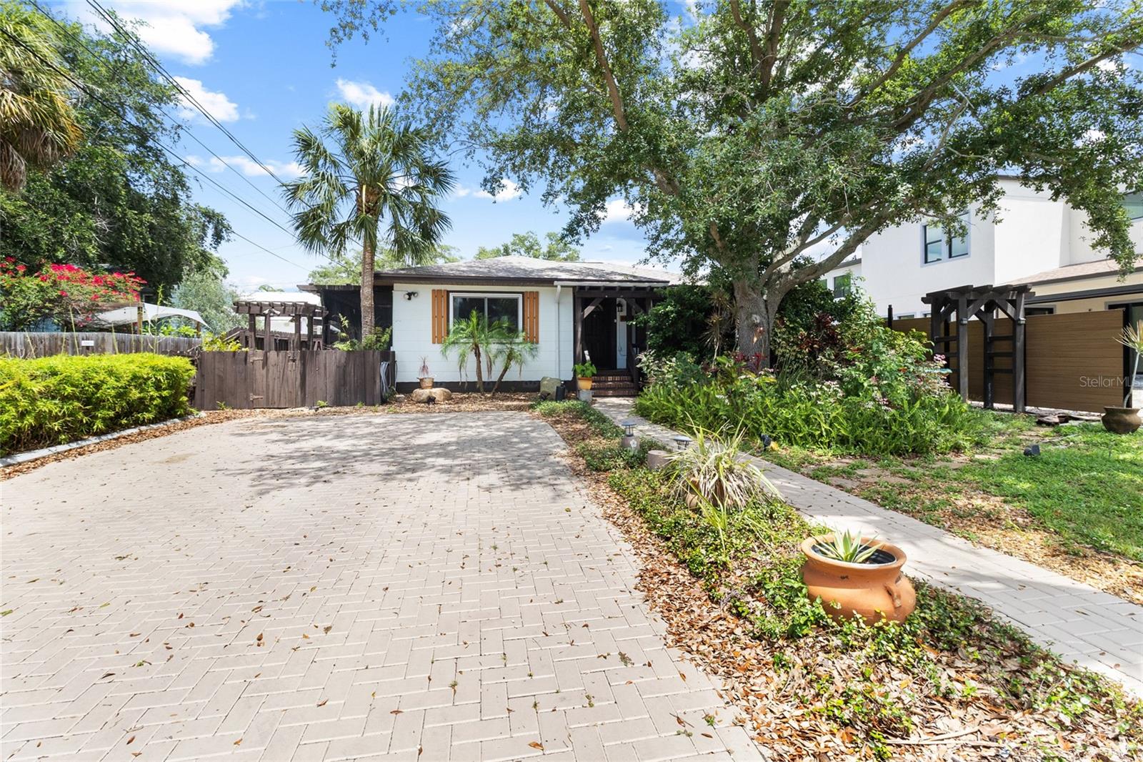 COME TO PARADISE! This charming Gulfport residence is nestled in one of the area's most desirable locations. Situated on an oversized lush green lot, this home is just a short stroll to Gulfport's vibrant waterfront district. This adorable Gulfport bungalow offers the perfect blend of Florida lifestyle, convenience, and historic neighborhood charm. Inside, you'll find a the perfect combination of historic charm and modern living, with refinished hardwood flooring and arched doorways that maintain the character yet, freshly painted walls and updated kitchen and baths, solid wood cabinets, hard surface countertops, and stainless steel appliances (including a gas stove!) bright and comfortable living spaces designed for everyday living and entertaining alike. With two spacious bedrooms and a bonus room, you will have plenty of room to host friends and family. The property features a functional layout, abundant natural light, and a welcoming atmosphere that immediately feels like home. The spacious yard provides plenty of room for outdoor enjoyment, gardening, pets, plenty of space to park your RV or boat, and still room for a pool! The oversized garage with it's stylish refinished floors has plenty of space for hobbies, to store your toys or that favorite car that you want to protect from the hot Florida sun. Located walking distance to Gulfport Beach, the historic downtown arts district, waterfront parks, local restaurants, boutiques, and community events, this home offers easy access to everything that makes Gulfport such a sought-after destination. Downtown St. Petersburg, award-winning beaches, and major transportation routes are just a short drive away. Whether you're searching for a primary residence, seasonal retreat, or investment opportunity, this property presents an exceptional chance to enjoy the relaxed coastal lifestyle of Gulfport while remaining close to all the amenities of the Tampa Bay area. Recent upgrades include: Completely remodeled garage with white shiplap walls, new tiled shower, new epoxy speckled floors, New metal garage side door, exterior house, driveway pavers & interior walls re-painted to a more modern look, New wooden window sills throughout house, Hurricane proof windows installed, Irrigation system serviced and set. This home is a true gem and a rare find in downtown Gulport, and is a MUST SEE!