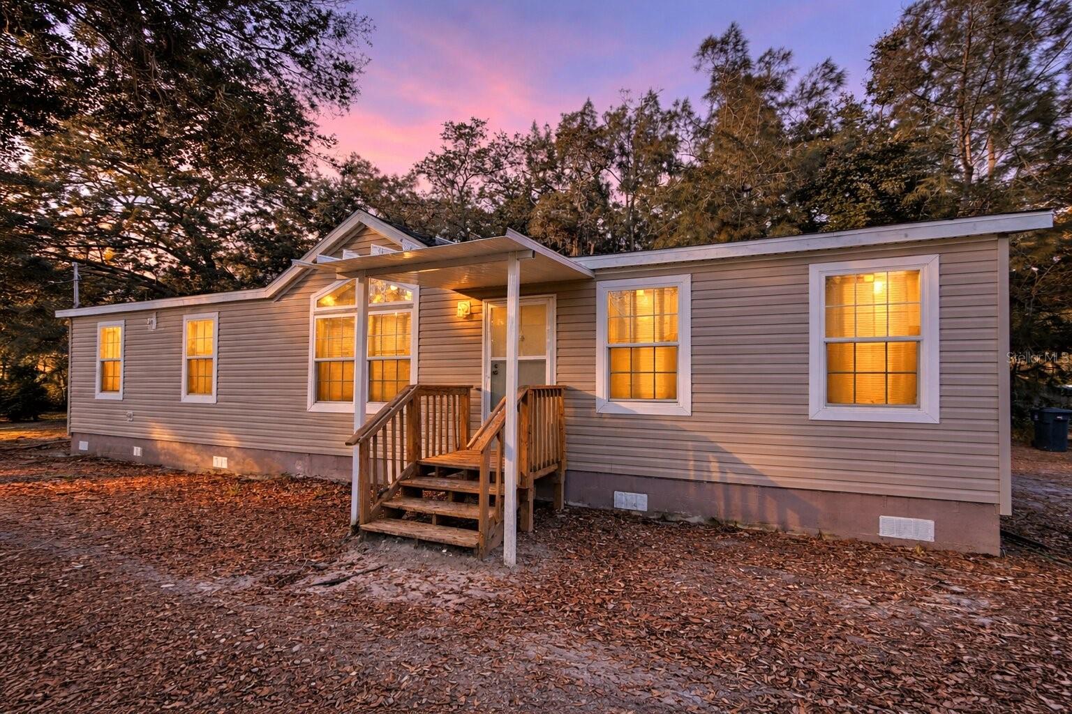 Live Now, Build Later on 1.4 Private Acres in Odessa • Second Driveway • Lake View Rare opportunity to own acreage in desirable Odessa with lake views and no HOA, offering the perfect combination of move-in comfort and future build potential. This well-maintained 2015 manufactured home features a spacious open layout, large kitchen with abundant cabinetry and counter space, generous primary suite with soaking tub, and updated major systems including newer AC (7 yrs), well and septic (7 yrs), and water softener (2 yrs). NEW luxury vinyl flooring throughout the entire home. A second driveway and ample space for a future custom home, workshop, RV storage, or multigenerational living make this property especially valuable and flexible. Enjoy peaceful wooded surroundings while still being just minutes from top-rated schools, shopping, and the Veterans Expressway for easy access to Tampa. Live comfortably now while planning your dream home later—properties with this much usable land in Odessa are increasingly hard to find.