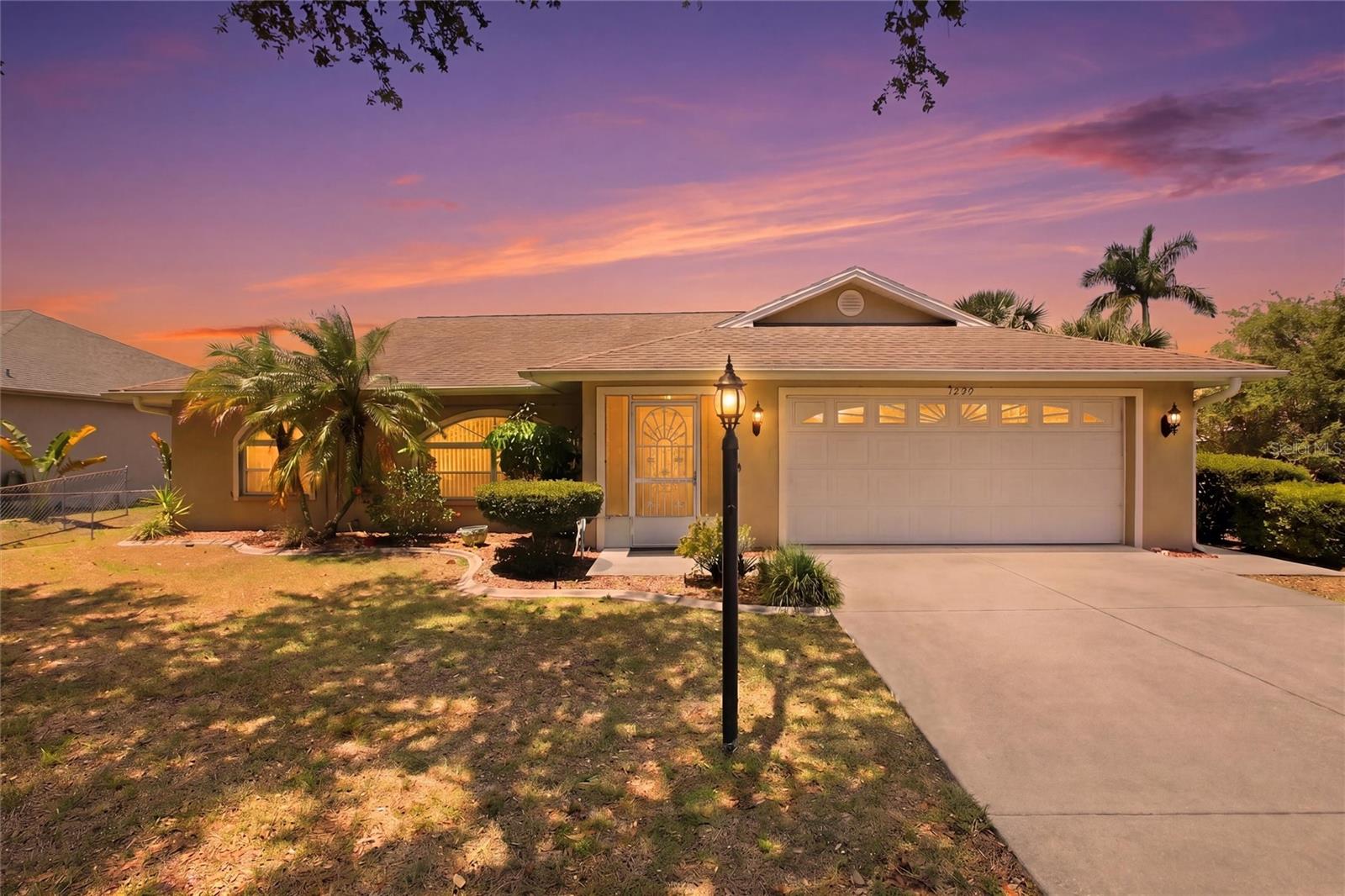Tucked into a quiet North Port neighborhood, this well loved and maintained 3 bedroom, 2 bath home offers a comfortable layout, thoughtful updates, and a setting that feels both private and functional. Inside, the split bedroom floor plan creates a natural flow for everyday living, with vaulted ceilings and large windows that bring in soft natural light throughout the main living spaces. The kitchen is designed for both ease and connection, featuring ample cabinetry, a breakfast bar, and seamless access to the dining and living areas. The primary suite includes a walk-in closet and private bath with walk-in shower, while the additional bedrooms give flexibility for guests, a home office, or growing needs. Step outside to a covered and screened lanai overlooking a spacious 10,000 sq ft lot, offering room to relax, entertain, or create your own outdoor retreat. A dock at the rear of the property adds an extra layer of lifestyle, ideal for enjoying the outdoors, fishing, or simply unwinding in your own backyard setting. There is a shed or extra storage as well. Recent updates include a roof replacement (2021) and new water heater (2021), providing added peace of mind. Additional features include a 2-car garage, indoor laundry, city water and sewer, and no HOA or deed restrictions. Conveniently located near I-75, shopping, dining, parks, and Gulf Coast beaches, this home exudes a balanced lifestyle with space, flexibility, and value.