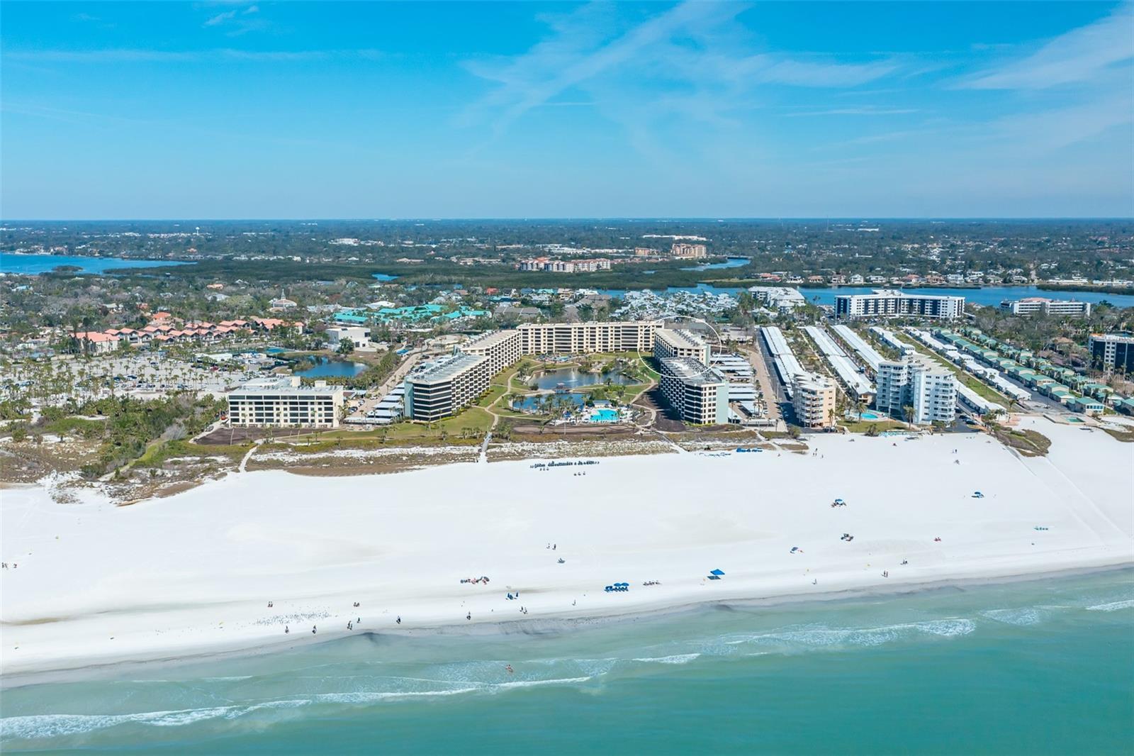 BEST VALUE AT SIESTA KEY BEACH GULF & BAY CLUB. Imagine living in Paradise…Welcome to your dream home on Siesta Key, where every day feels like a vacation. This beautiful beachfront corner unit in the prestigious GULF & BAY CLUB is located on the #1 Beach in America per Trip Advisor. Step into this stunning two-bedroom, two-bathroom unit, filled with natural light from expansive windows. Enjoy breathtaking sunrise and sunset views as part of your daily routine. The renovated interior features high ceilings, a gourmet kitchen with an office, modern bathrooms, smart storages and elegant details. Gulf & Bay Club is the gated resort community on the key. The serene property spans on 32 acres with 800 feet of private quartz sand beach, offering exceptional living. Beyond your home, Gulf & Bay Club offers world-class amenities, including scenic pathways to a freshwater lake with a rustic footbridge, a lush tropical courtyard with 3 heated pools, 6 pickleball courts, 4 tennis courts, 2 clubhouses and barbecue grills for social gatherings. Fitness enthusiasts can access a commercial gym, sauna, and media facility, while EV charging stations promote eco-friendliness. With an on-site rental management for one-month minimum rentals, this property is perfect for luxurious living and smart investment. Make this waterfront oasis your home where warm hospitality and serenity await.