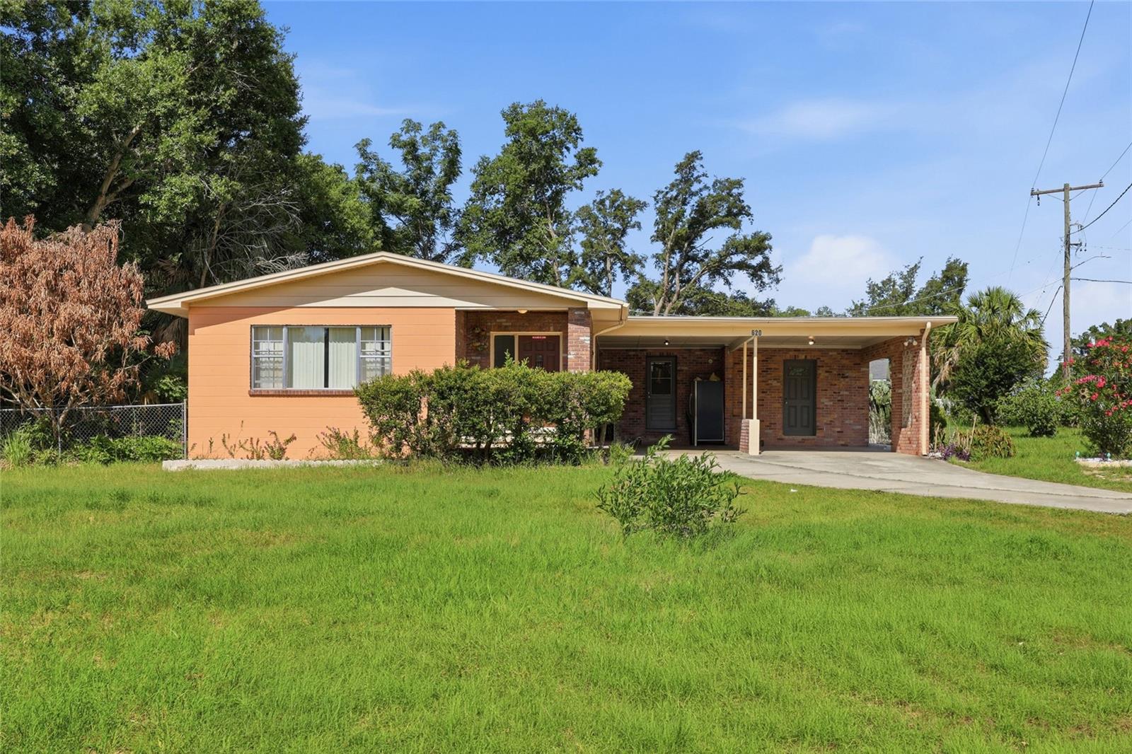 Charming 3/2 block home on a corner lot in the heart of Lake Alfred! This solid, well-built home features 1,650 sqft of living space, a fenced backyard with fruit trees, and a 2-car carport with plenty of room inside and out. The brick/stucco exterior gives it great curb appeal, and the updated shingle roof offers peace of mind. Whether you're a first-time buyer or investor, this one checks the boxes. Convenient to US-27, Winter Haven, and Lakeland. Don't miss it!