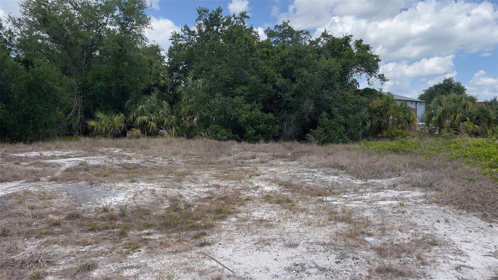 This commercially zoned vacant lot offers an excellent opportunity for development in a growing area of Charlotte County. Measuring approximately 50 x 125 feet, the property is mostly cleared and located in an X Flood Zone, offering added peace of mind and potential insurance savings. Surrounded by established commercial buildings and businesses, the location provides strong visibility and convenient access for a variety of commercial uses.
Situated just 1.5 miles from Interstate 75, the property offers quick connections to Punta Gorda, Deep Creek, and Harbour Heights, as well as easy access to the Punta Gorda Airport. Whether you are looking to expand your business footprint, expand your storage potential or invest in commercial land, this property presents a prime opportunity in a strategic location.