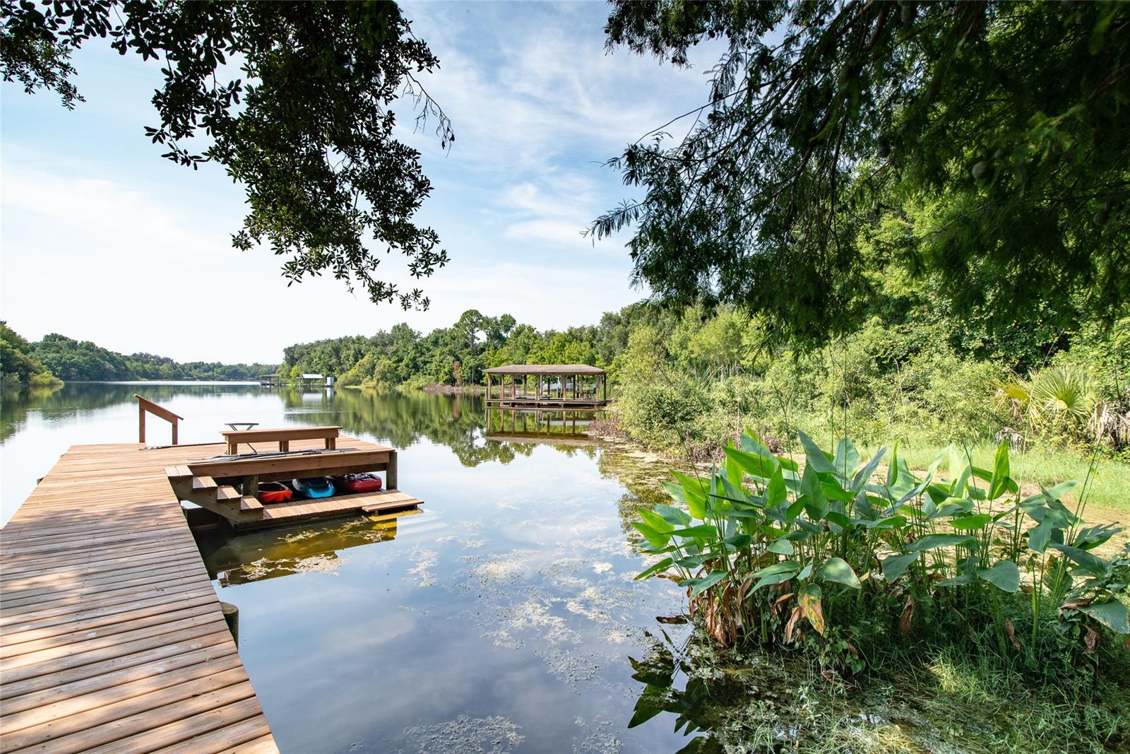 Where to start ! ? This custom designed and built lake front home is everything a family could want. Not just a great home, but a lifestyle. Lake Waterford, a gated community, may be the best kept secret in New Smyrna Beach. Light and airy home with lots of windows and lake views from most rooms. Quality stem wall construction, fine finishes, fixtures, and lighting with shiplap throughout the core of the house. Generous master BR with a hallway of closets leads to sumptuous master bath featuring a double shower and hot tub. Beautiful Sun Room with windows on three sides and lake view.  Screened porch and  fire pit patio overlook the dock and lake. Enjoy fishing, canoeing, or kayaking off your own dock. Or water ski on the slalom course. Community features a clubhouse, tennis, pickle ball, and basketball courts and a boat ramp. Much more. Gas appliances including dryer. Third garage pre planned to convert to office including central air. Storage under dock for kayaks and paddle boards. Come see ! ;Water: City