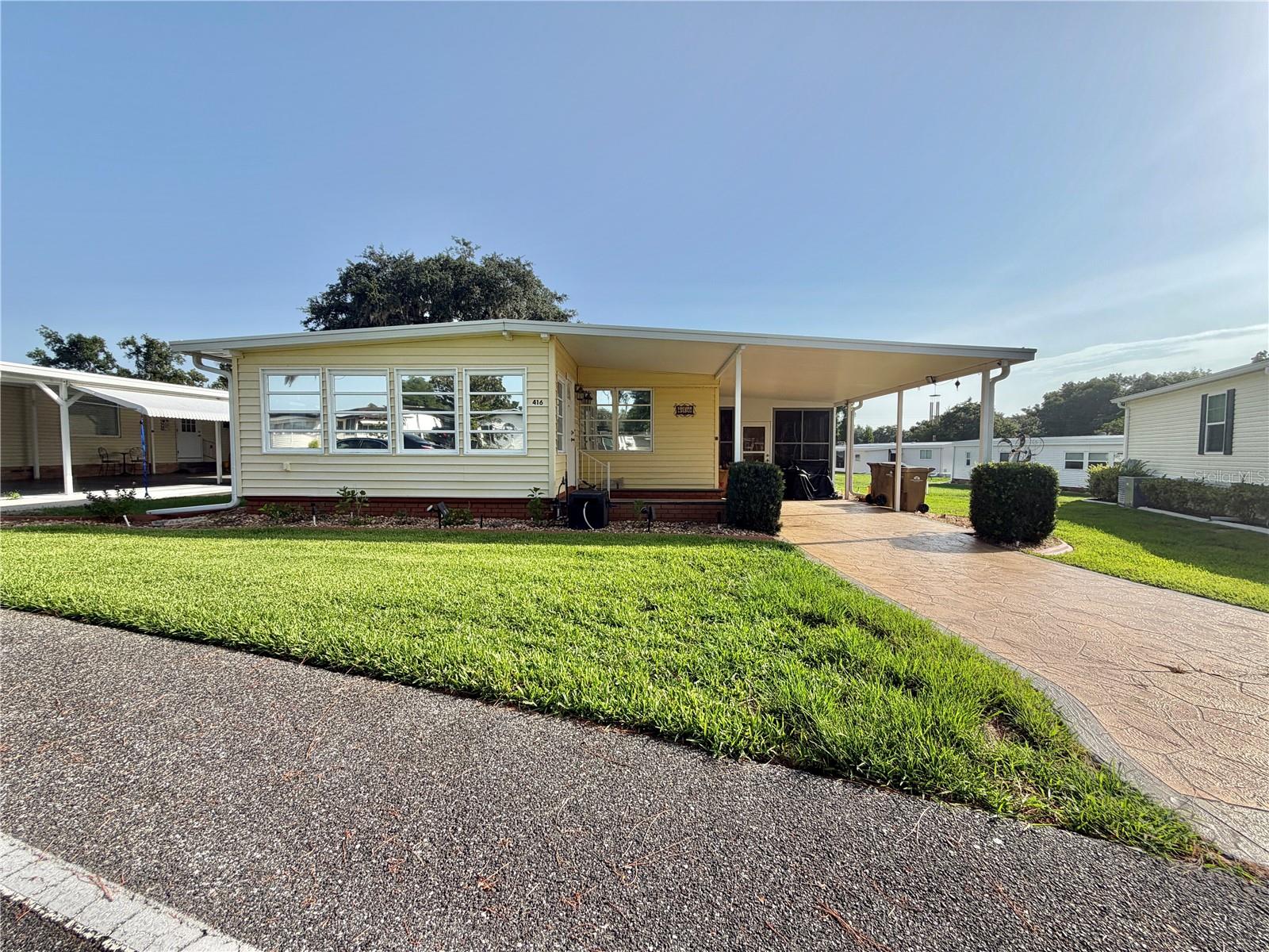 Welcome to this exceptional home on sought-after Palo Verde Drive, where comfort, convenience, and endless potential come together. Offering 1,408 square feet of inviting living space, plus a 168-square-foot heated and air-conditioned utility/laundry room, a climate-controlled Florida room, and an enclosed sunroom with new windows, this home provides an abundance of flexible space to fit today’s lifestyle. Whether you’re entertaining guests, pursuing hobbies, working on projects, or simply relaxing, there’s room for it all.
The spacious kitchen features abundant cabinetry and generous counter space, creating a welcoming gathering place for everyday living and family meals. Just off the kitchen, the dedicated dining room offers built-in cabinetry and a convenient serving counter, providing additional storage and the perfect space for entertaining or displaying your favorite décor. Both bathrooms have been thoughtfully updated, with a walk-in shower in the primary suite and a relaxing tub in the guest bath. The primary bedroom serves as a private retreat with direct access to the covered 60-square-foot screened back porch, the perfect spot to enjoy your morning coffee or unwind at the end of the day. The guest bedroom includes built-in shelving, offering added functionality and storage. A long list of valuable upgrades provides comfort, efficiency, and peace of mind, including a membrane roof (2019), two HVAC systems (2014 and 2019), a new electrical panel, energy-efficient tinted windows, updated primary bedroom windows, durable vinyl siding, and an attractive stamped concrete driveway. While the home is ready to enjoy, it presents an excellent opportunity to personalize the interior and create a space that reflects your own style and vision. Designed with modern convenience in mind, the property also features two EV charging stations with a Tesla adapter, a dedicated golf cart charging station, and a whole-house receptacle for a 12,000-watt dual-fuel generator. With its generous living spaces, extensive upgrades, and desirable location on Palo Verde Drive, this home offers outstanding value and an exceptional opportunity to enjoy the Florida lifestyle...........Hawthorne at Leesburg is an active, resident owned, 55+ cooperative, waterfront, gated community, with beautifully landscaped grounds, lakes with illuminated fountains and a relaxing and comfortable gazebo. The affordable monthly maintenance fee of $397 includes water, sewer, lawn mowing, private emergency services and storage space for recreational vehicles, boats, trailers and much more! The beautiful clubhouse is complete with a full-time program coordinator, more than 100 different activities and seating for 550. It has a hospitality lounge, card rooms, craft rooms, billiard room, fitness center, library, fine arts room and many more. There is excellent fishing, outdoor geo-thermally heated pool and two enclosed therapeutic pools. Hawthorne boasts a private marina monitored by an electronic security system with over 120 boat slips and access to the Harris Chain of Lakes and beyond.