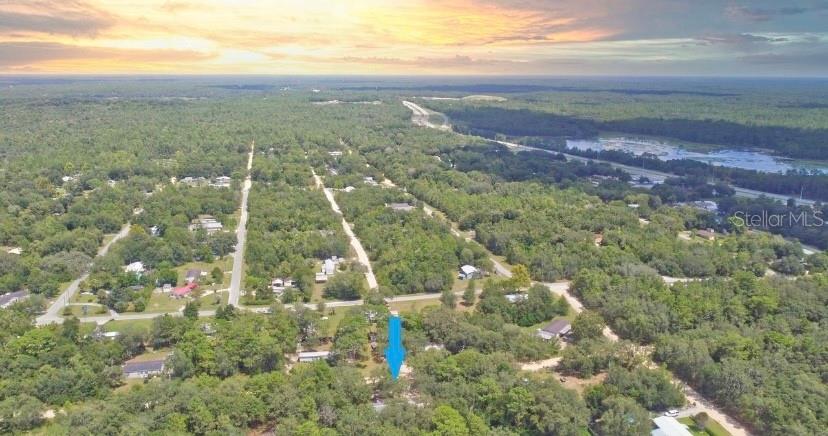 Discover the potential of this beautiful 1.84-acre vacant lot, nestled in a serene and picturesque location. The property offers a unique blend of privacy and convenience, making it an ideal place for your dream home or investment. **Key Features** The majority of the lot is cleared and ready for development, with just a hint of natural growth adding to its charm. Corner posts are installed, clearly outlining the property and ready for your custom fencing plans. Gorgeous large oak trees have been preserved at the planned site for a house and/or shop, providing a natural canopy and aesthetic appeal. The lot features a convenient half-moon driveway, ensuring easy access and thoughtful design. Although there is a light pole from Clay Electric on the premises, power is not yet connected. However, this provides a head start for utility setup. Water installation is still needed as no well has been dug. 15 connected lots, this parcel provides an abundance of space for various configurations or future expansion. Just one block from a paved road, the property is strategically located near Gainesville, Ocala, and Saint Augustine, and is about an hour from the new Bass Pro store. This property is high, dry, and not located in a flood zone, providing peace of mind. Whether you're looking to build a personal retreat or invest in growing communities nearby, this lot is a blank slate awaiting your creativity. Contact me today for more details and to explore this exciting opportunity!