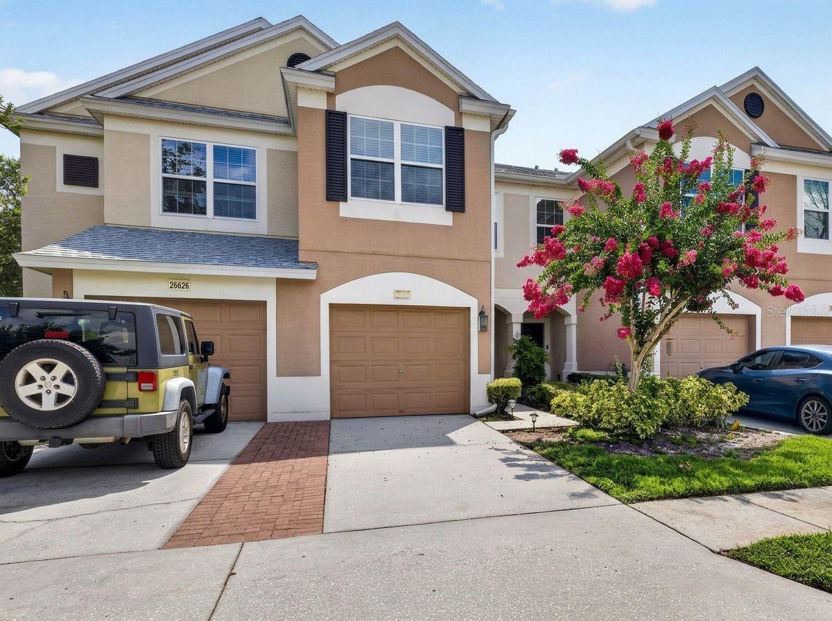 Maintenance-Free Living in a Prime Location — Stylish 3BR Townhome in Gated Bay at Cypress Creek

Welcome to effortless living in the sought-after Bay at Cypress Creek, a gated community known for convenience, comfort, and a true lock-and-leave lifestyle. This beautifully maintained 3-bedroom, 2.5-bath townhome sits in one of the most desirable spots in the neighborhood—just steps from the community pool, clubhouse, and ample guest parking.

Location truly sets this home apart. You’re only minutes from the Tampa Premium Outlets, endless dining options, and everyday essentials. With a new A/C system and a roof replaced within the last four years, major updates are already taken care of.

Inside, the open floor plan creates a bright, welcoming atmosphere perfect for both relaxing and entertaining. Enjoy peaceful mornings or unwind in the evenings on your screen-enclosed porch, offering tranquil nature views with no rear neighbors.

Upstairs, all bedrooms are thoughtfully arranged in a split bedroom layout. The spacious primary suite features a walk-in closet and a comfortable en-suite bath with a shower/tub combo. Down the hall, you’ll find two oversized guest bedrooms, the main bath, and a conveniently located laundry closet.

Your monthly fee covers water, trash, cable, exterior maintenance, and pool access, giving you true maintenance-free living and more time to enjoy the lifestyle you deserve.

This townhome checks all the boxes—location, updates, privacy, and convenience. Don’t miss the chance to make it yours.